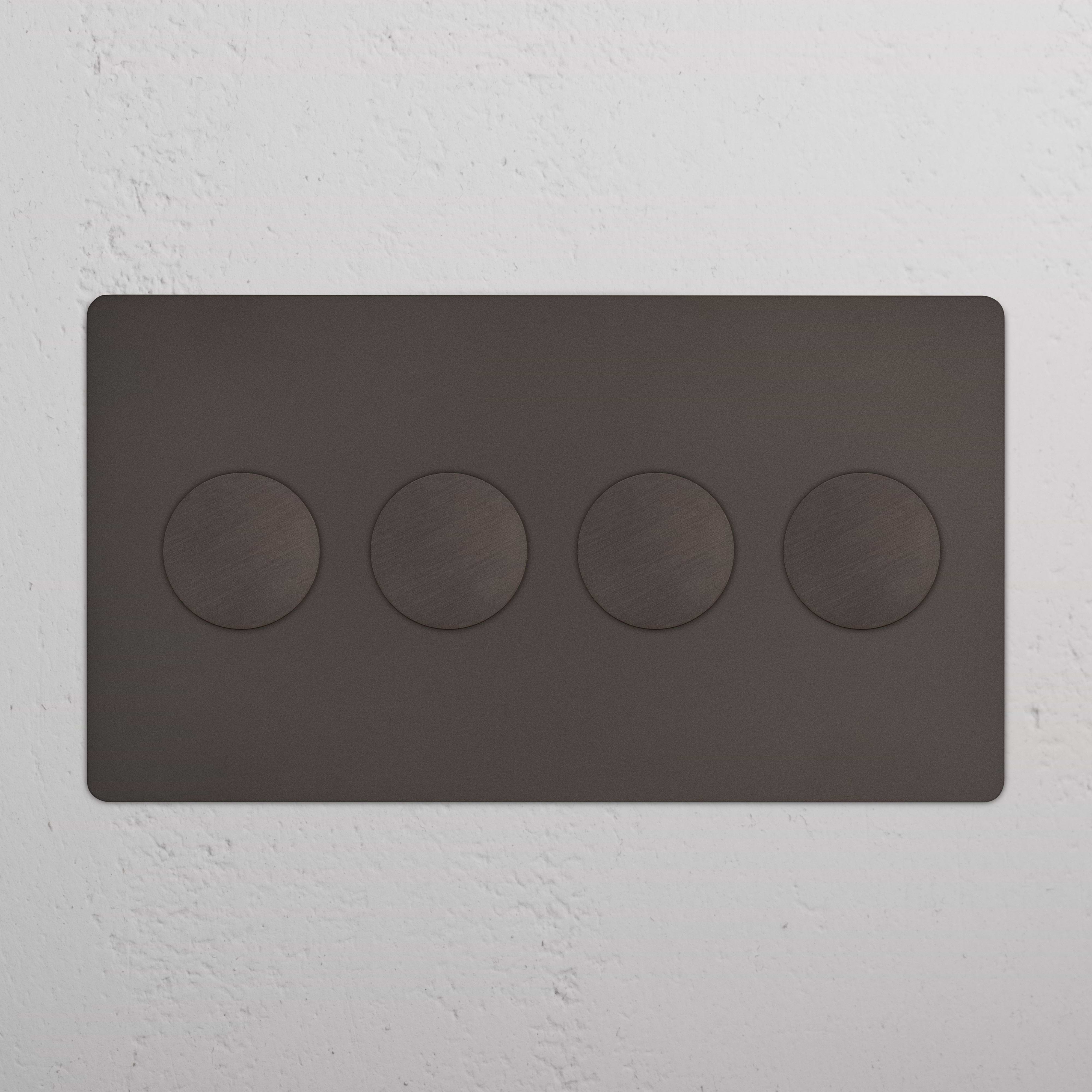 Kew 4G Dimmer Switch in bronze with four round knobs on a rectangular wall plate, mounted on a white wall.