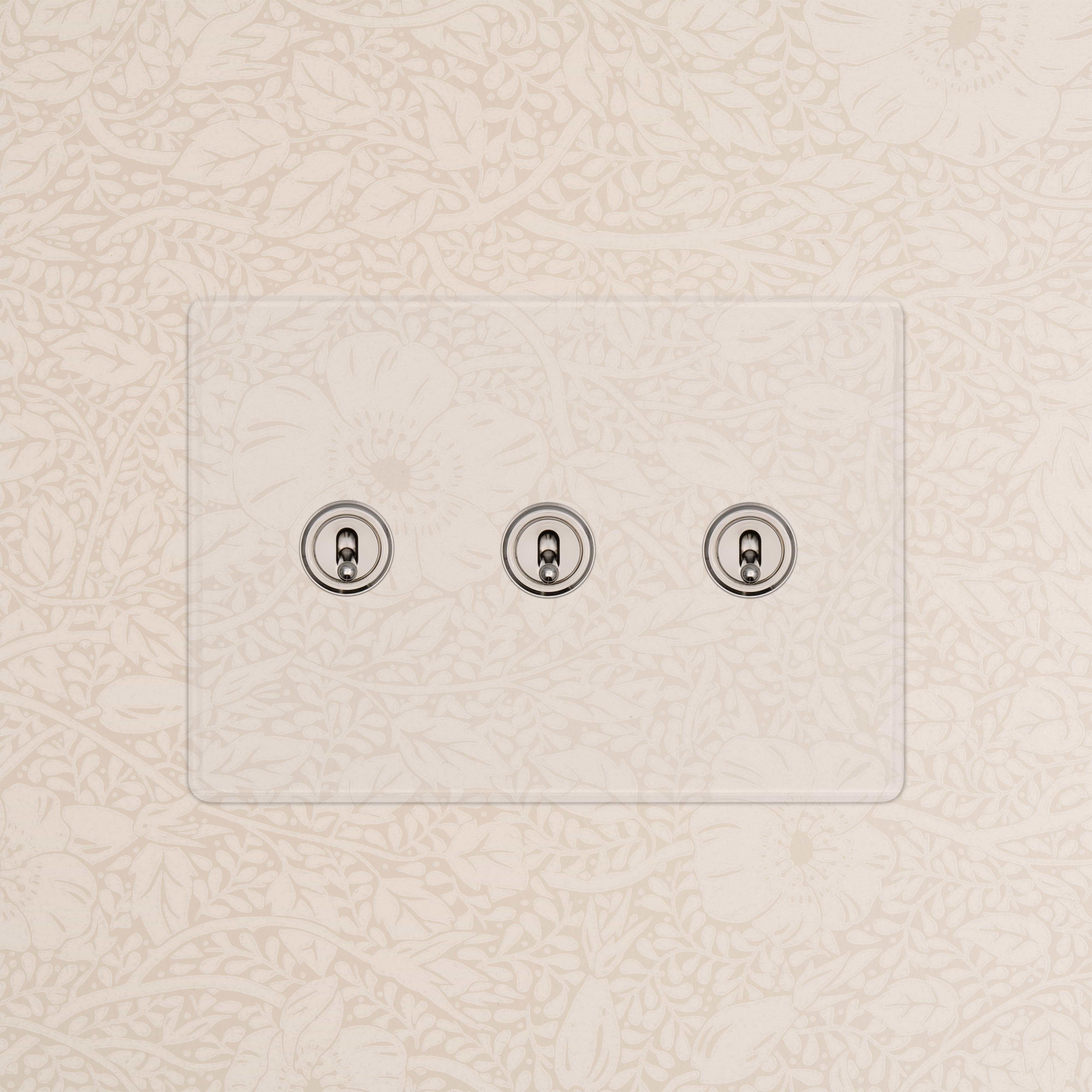Kew 3G Toggle Switch in Clear Polished Nickel, mounted on a glass panel for wall light control.