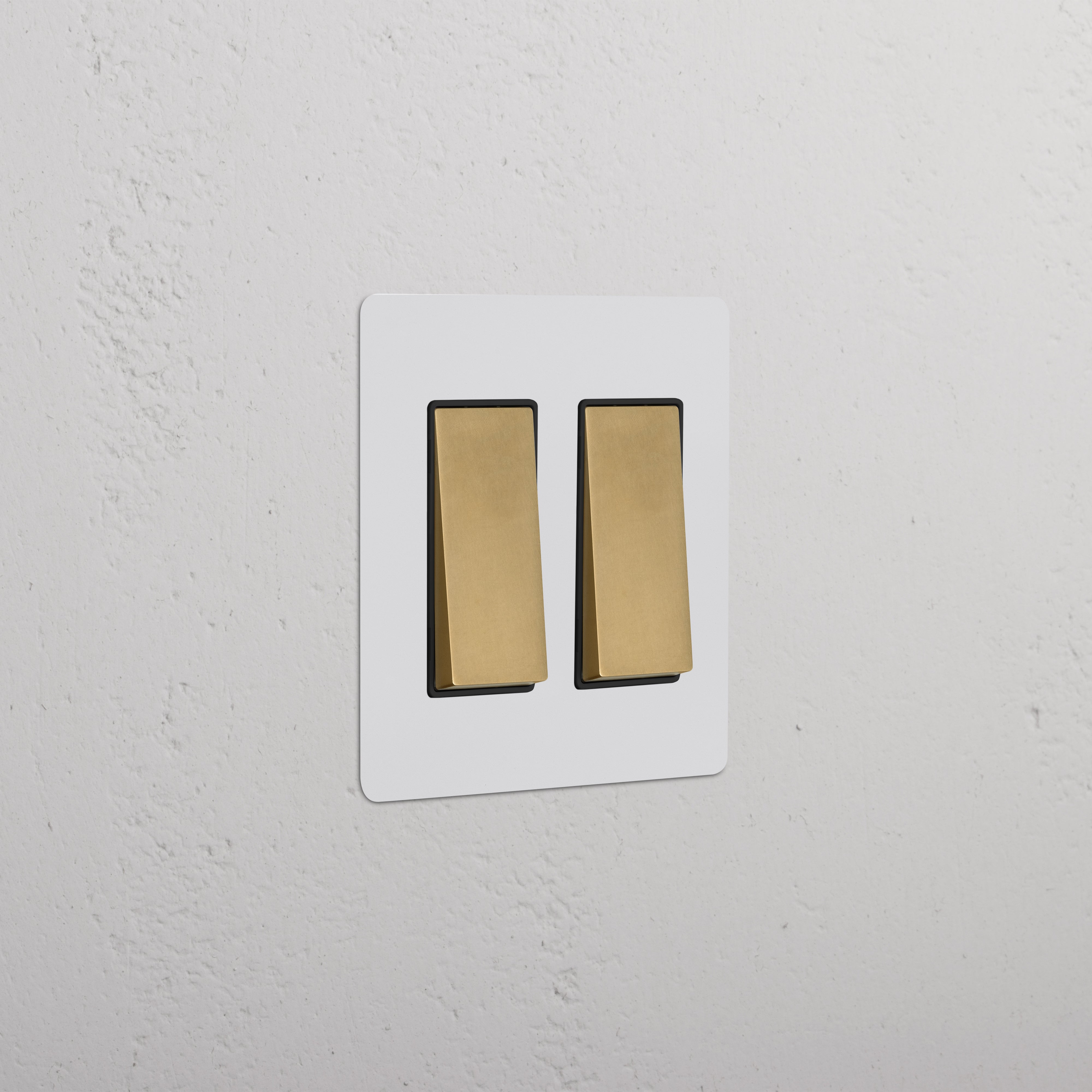 Kew 2G Rocker Switch in paintable antique brass black finish, mounted on a wall.
