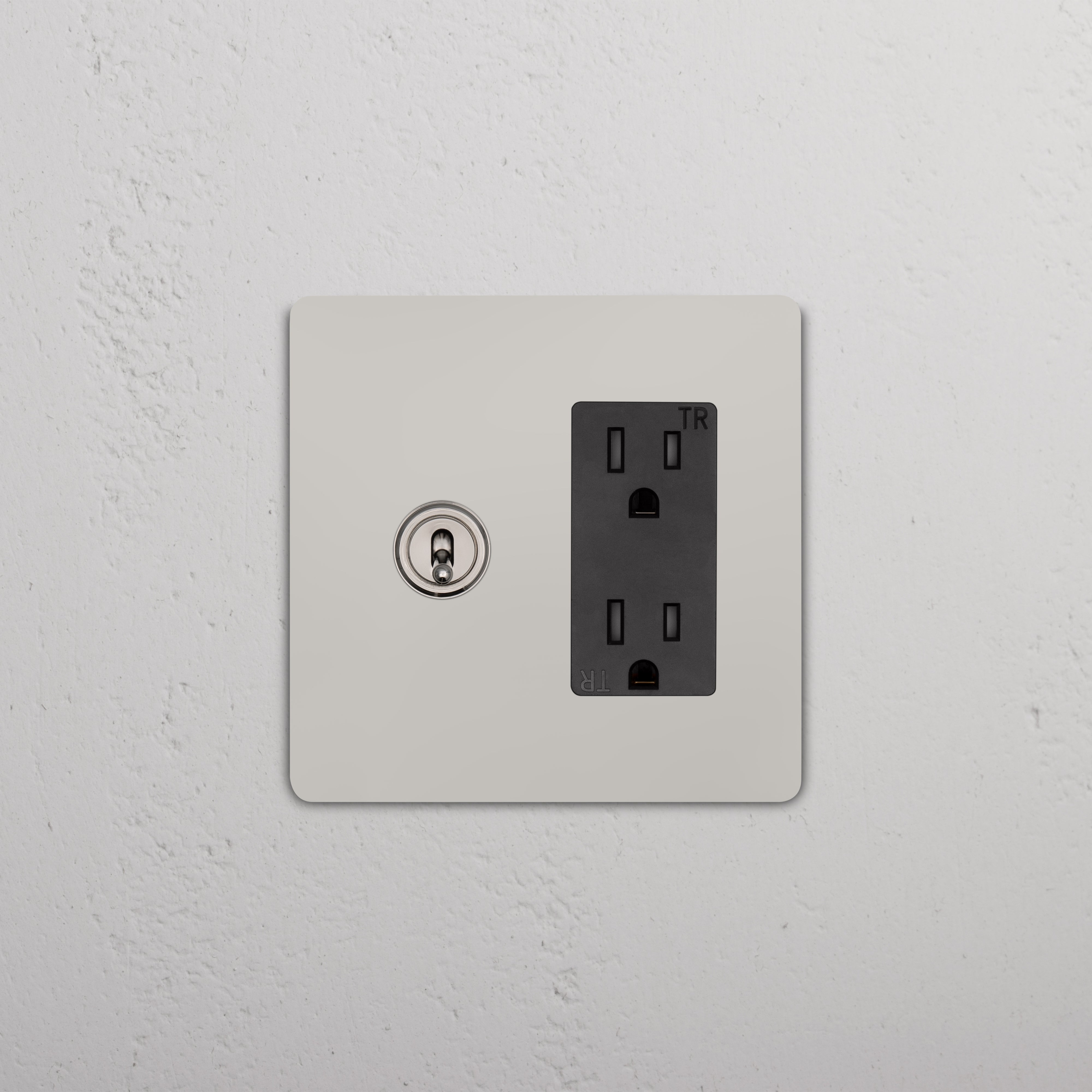 Grove 2G Toggle Switch & Outlet in polished nickel black on a white wall plate, mounted on a textured wall.