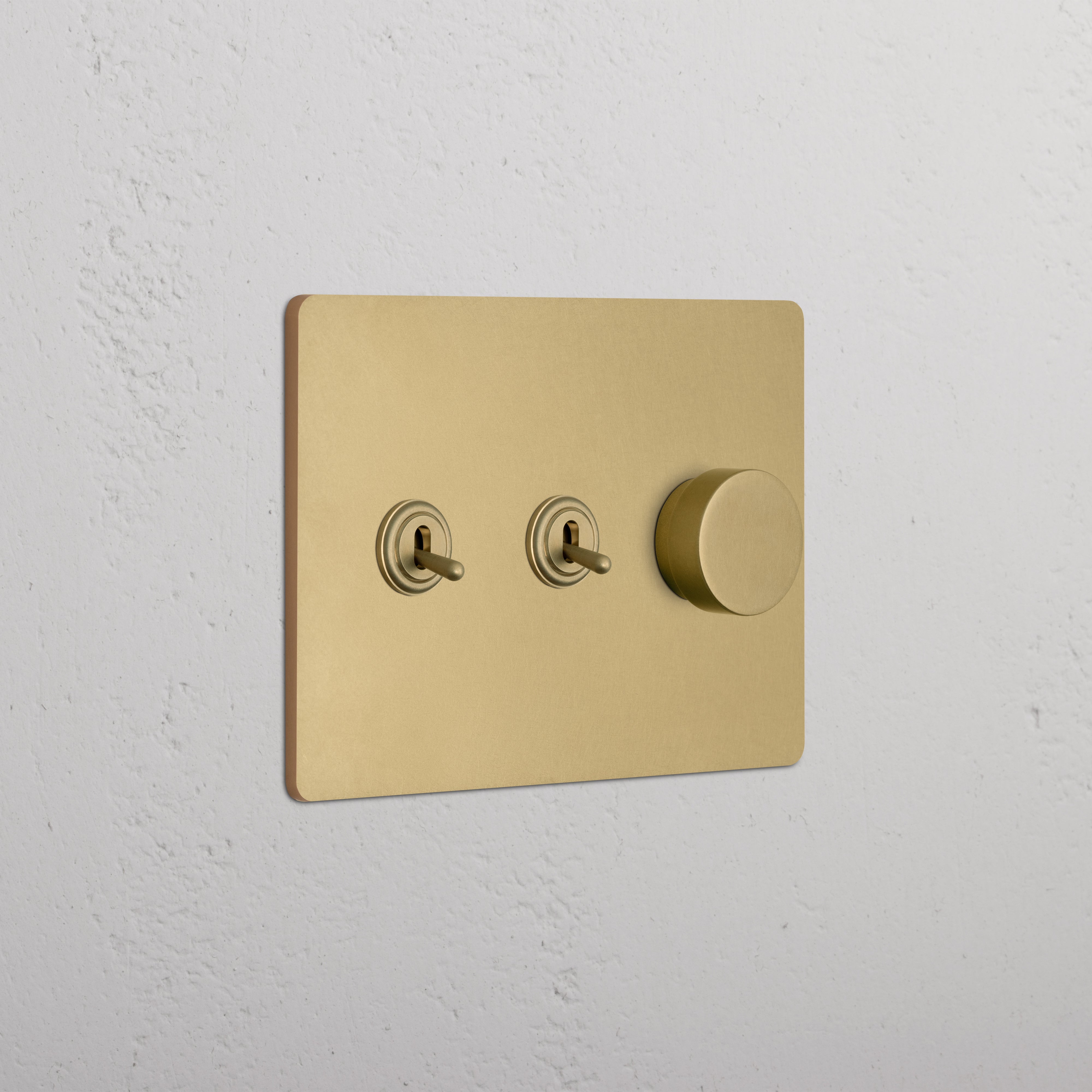 Grove 3G Antique Brass wall plate featuring two toggle switches and one dimmer switch.