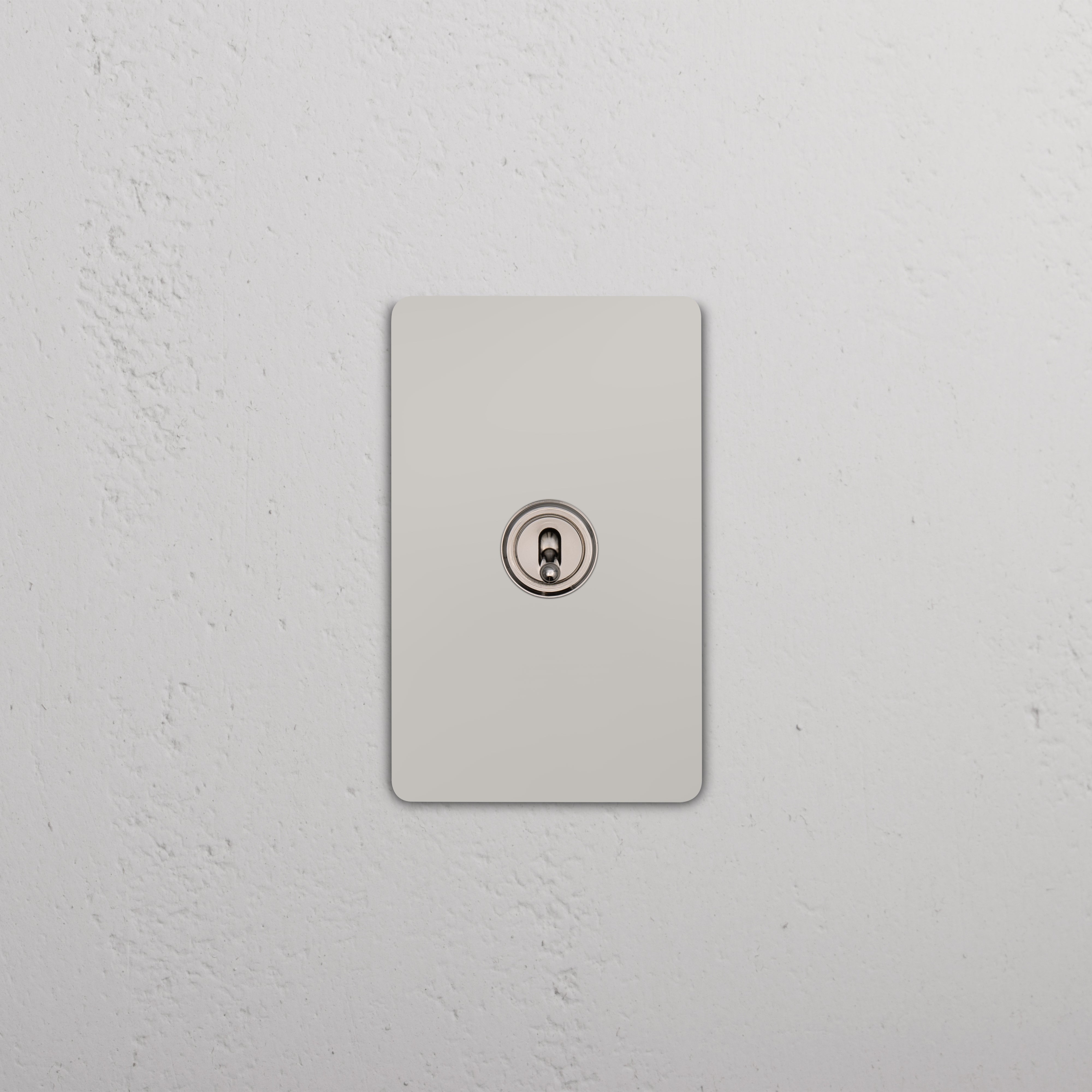 Grove 1G Four Way Toggle Switch in polished nickel finish on a rectangular wall plate.