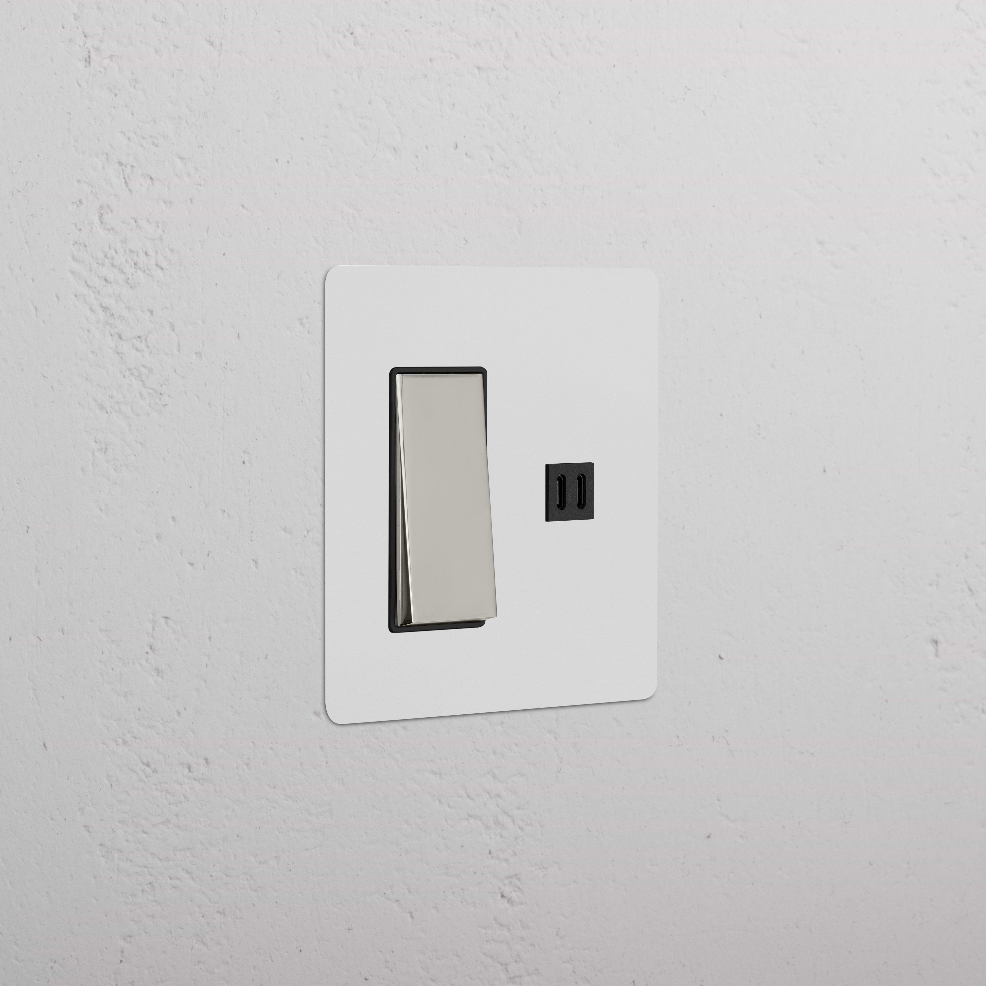 Kew 2G Rocker Switch & Fast Charge USB in paintable polished nickel black, mounted on a wall.