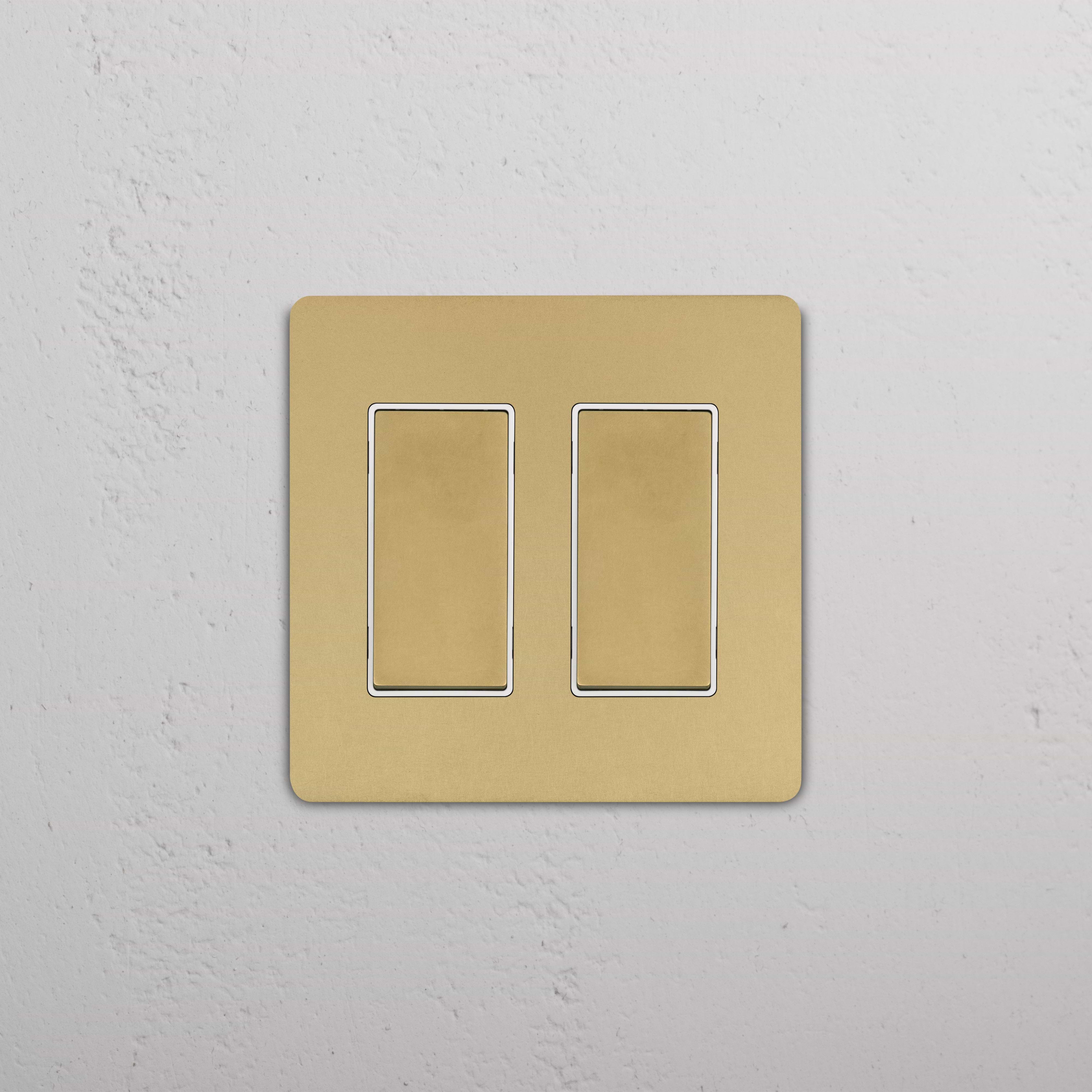 Grove 2G Rocker Switch in Antique Brass White finish with dual rectangular rocker buttons.