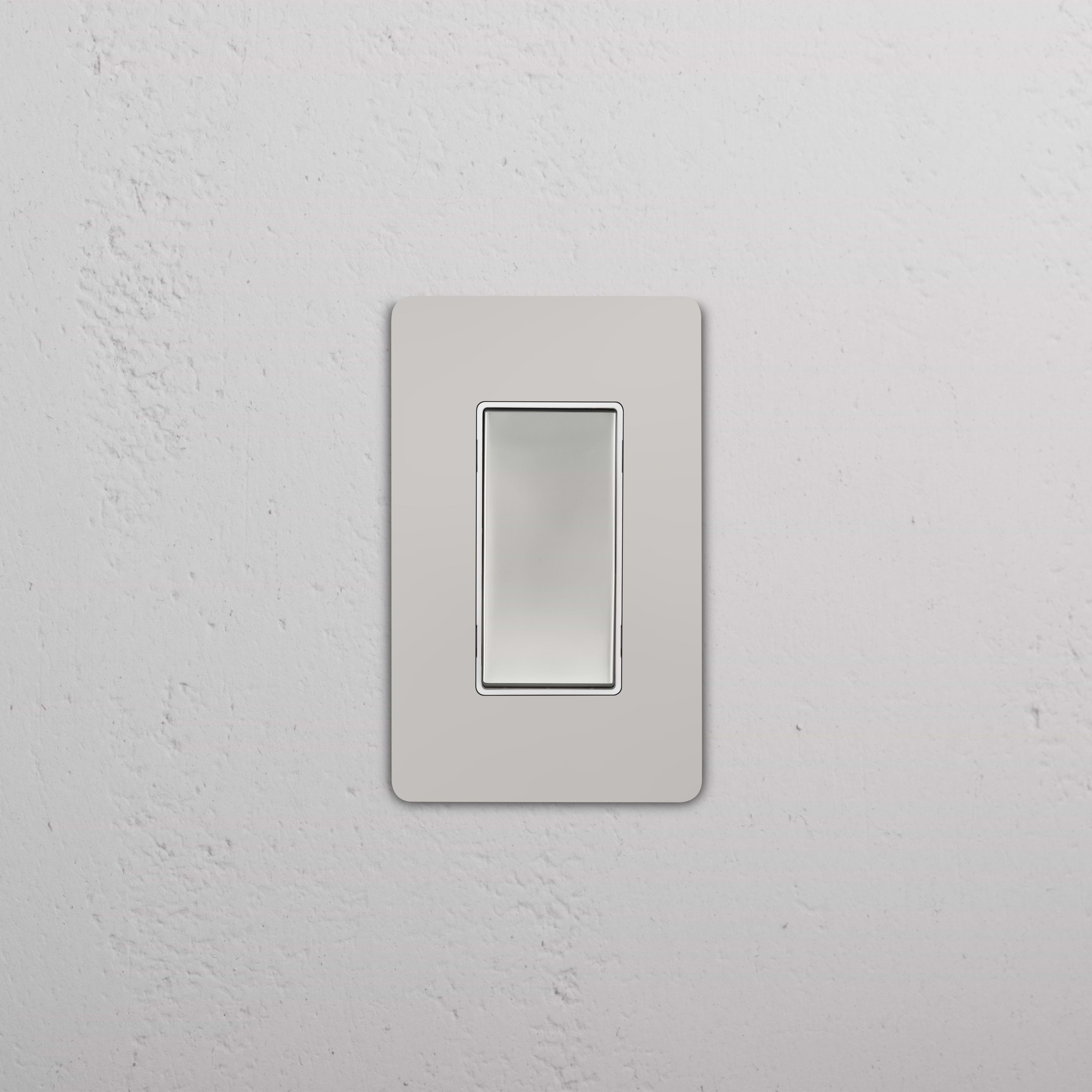 Grove 1G Rocker Switch in polished nickel white finish, mounted on a white textured wall.