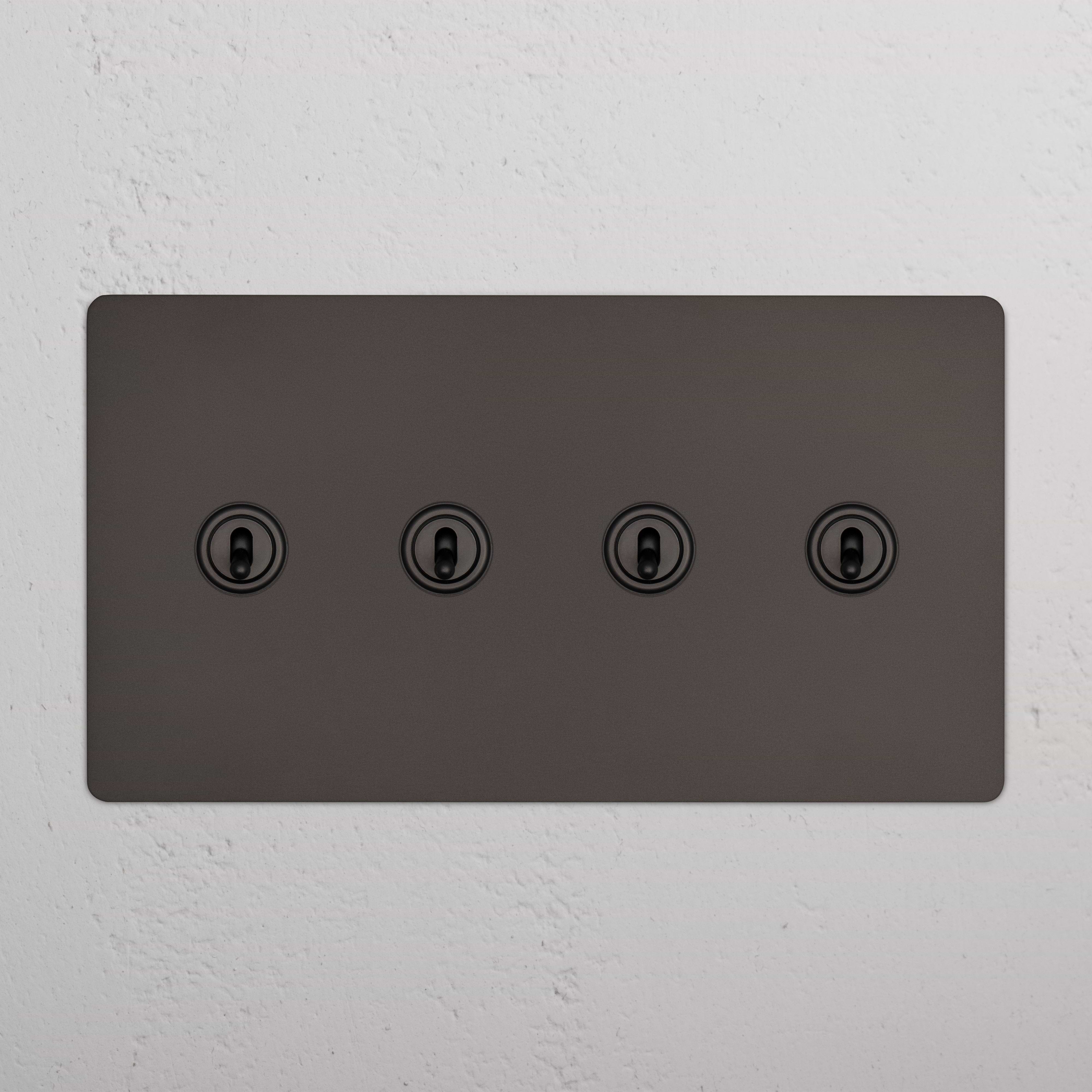 Bronze Kew 4G Toggle Switch panel with four round toggles, mounted on a white textured wall.