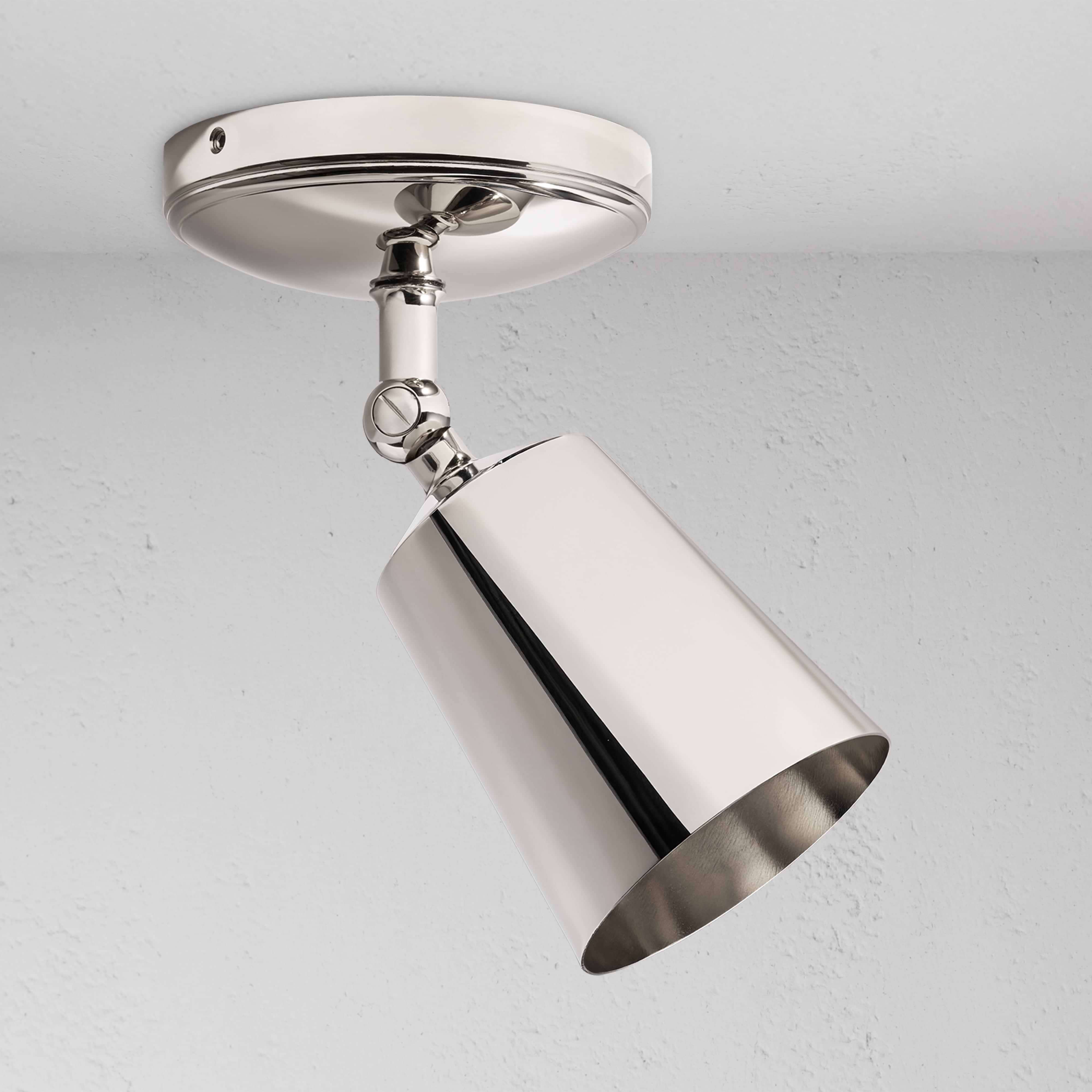 Baylis Single 70mm Spotlight in polished nickel with a sleek cylindrical shade, mounted on a ceiling.