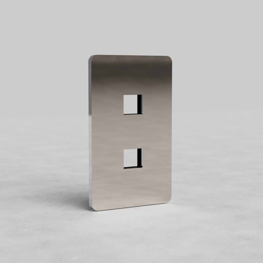Polished nickel 1G 2x Keystone Plate Grove US with two vertical keystone slots on a light gray surface.