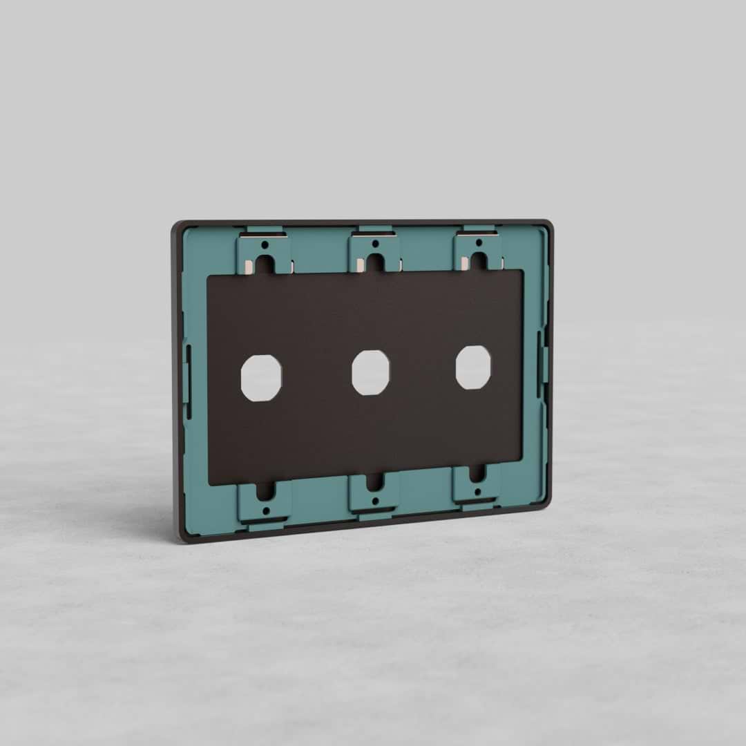 Bronze 3-gang switch plate (Grove US) with three switch openings, shown on a plain light gray surface.