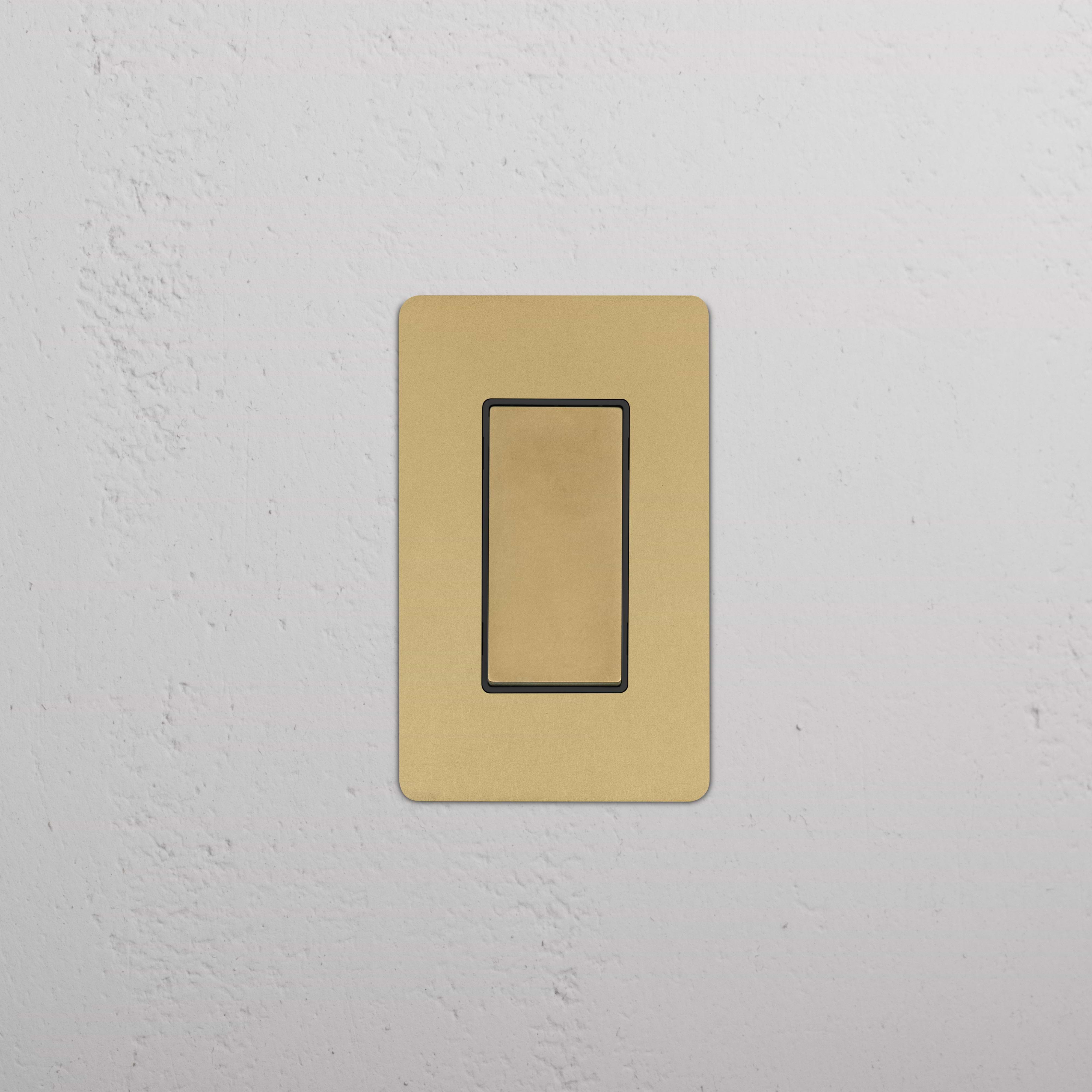 Kew 1G Four Way Rocker Switch in Antique Brass Black, shown mounted on a wall for electrical control.