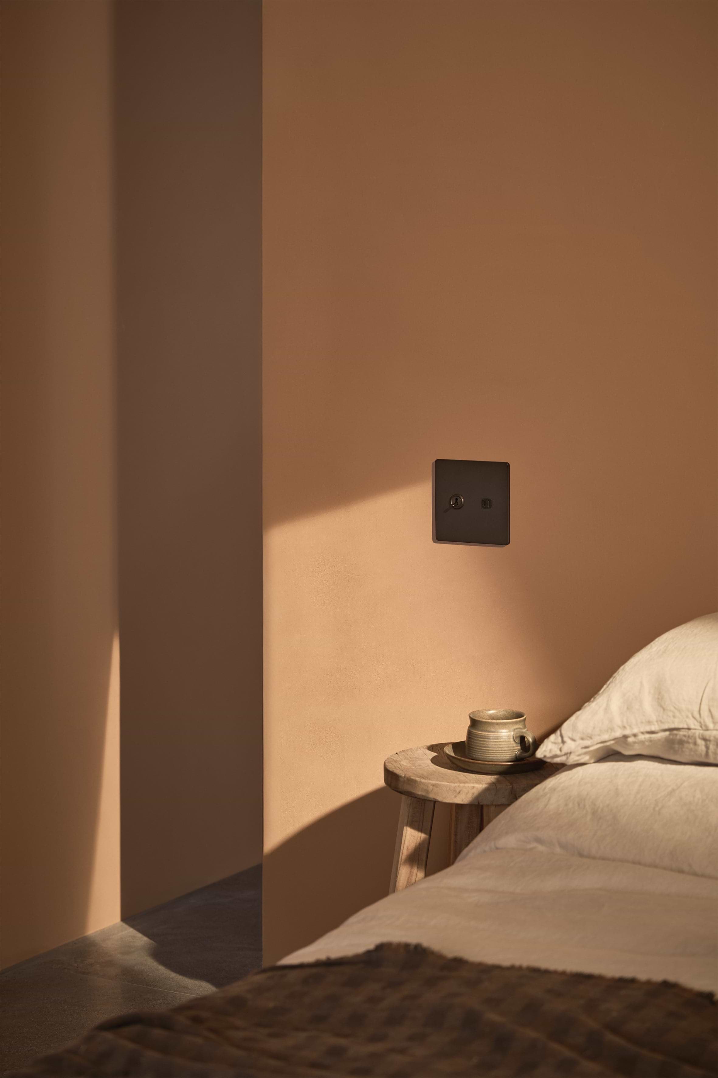 Grove 2G Toggle Switch & Fast Charge USB in Bronze Black installed on a wall, modern and functional design.