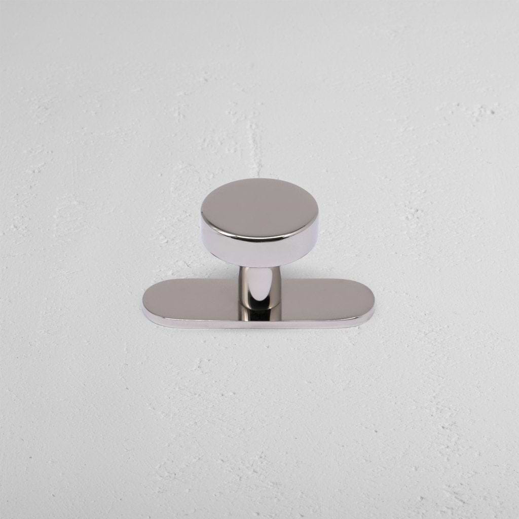 Kilburn Furniture Knob in polished nickel finish, featuring a round, smooth top and simple metal base.