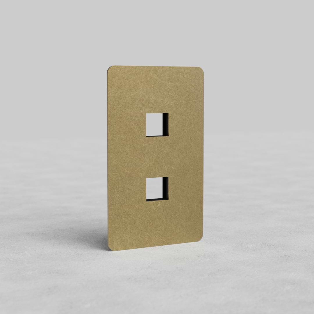 Antique Brass 1G 2x Keystone Plate Kew US with two vertical keystone slots, shown on a light gray surface.