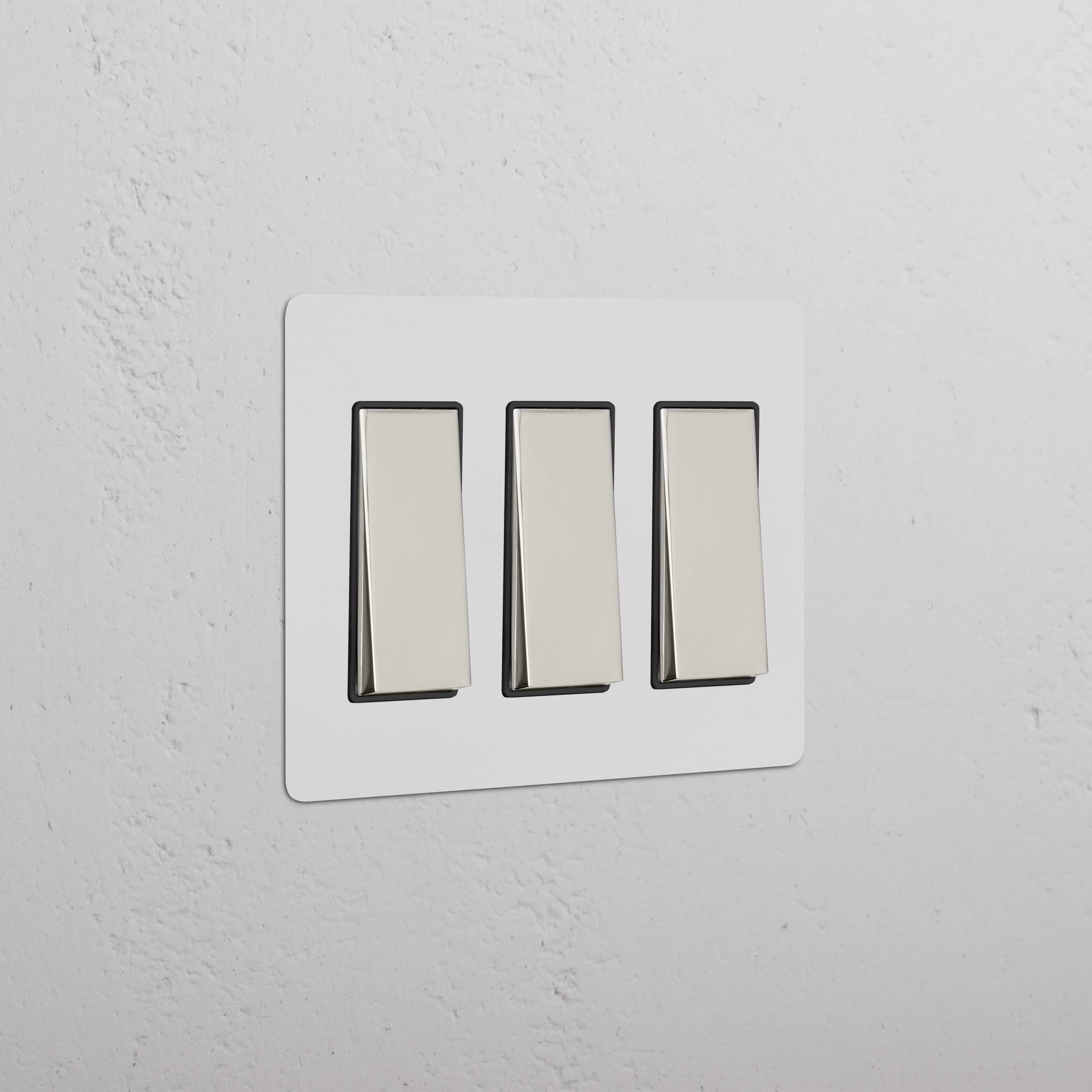 Kew 3G Rocker Switch in Paintable Polished Nickel Black finish, showing three modern rocker switches.