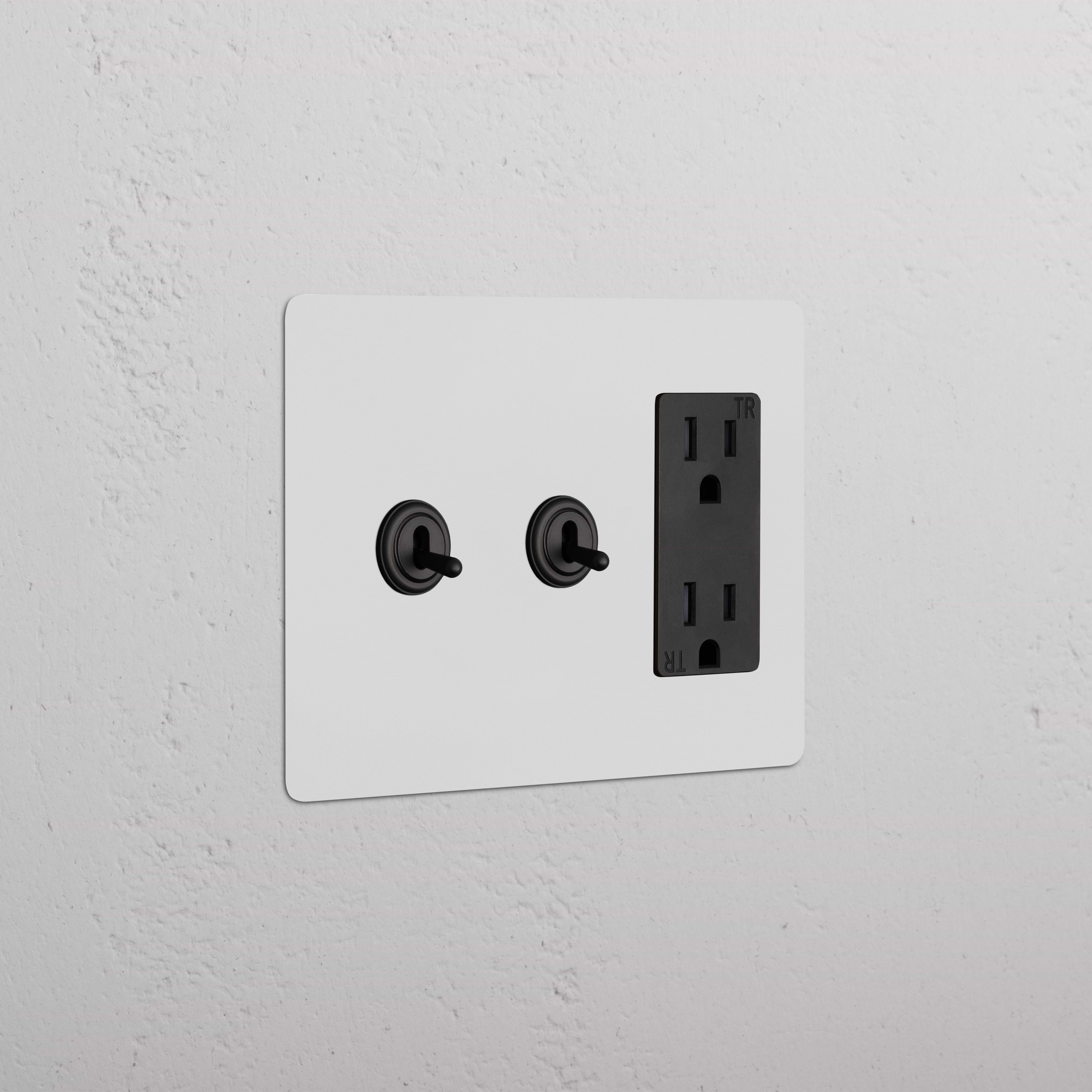 Kew 3G 2x Toggle Switch & Outlet in Paintable Bronze Black with two toggle switches and one outlet on a wall plate.