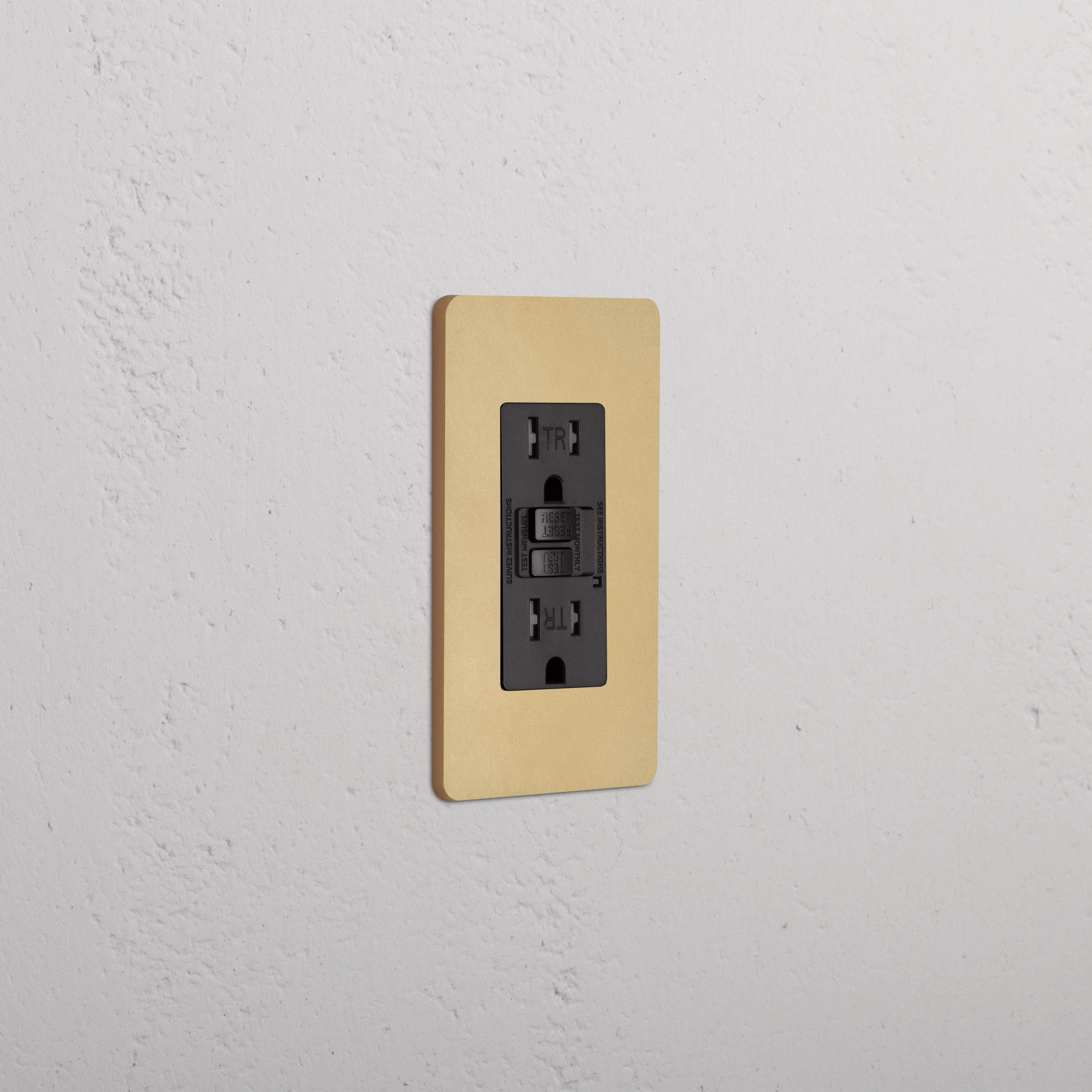 Grove 1G 15A GFCI Outlet in Antique Brass Black finish with test and reset buttons on a wall plate.