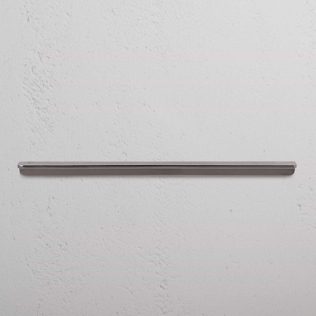 Large Oxford Furniture Handle in polished nickel, mounted horizontally on a white textured wall.