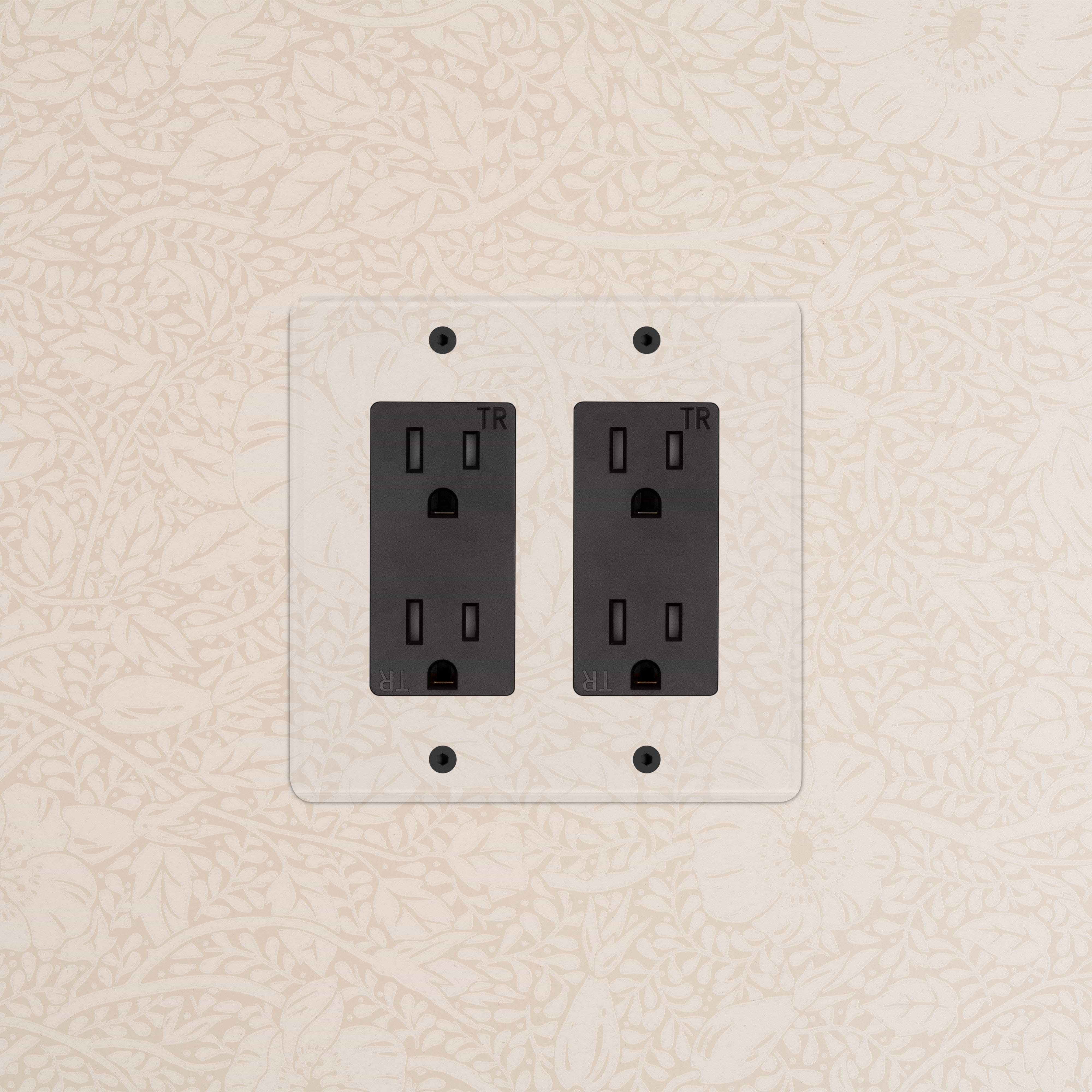 Kew 2G Outlet in clear black finish with two electrical sockets, mounted on a wall.