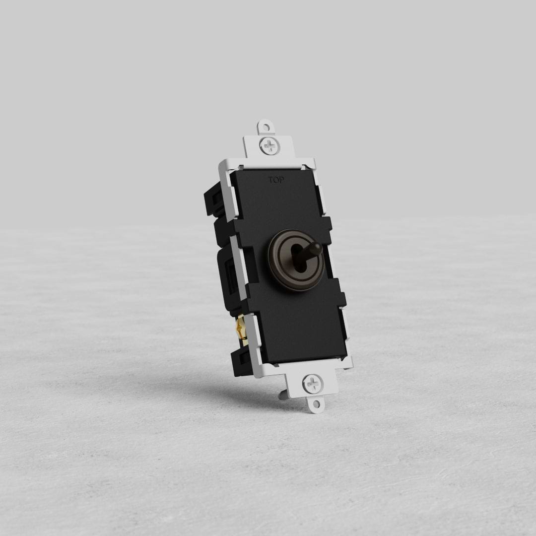 Bronze Center Retractive Toggle Switch displayed upright on a light gray textured surface against a plain background.