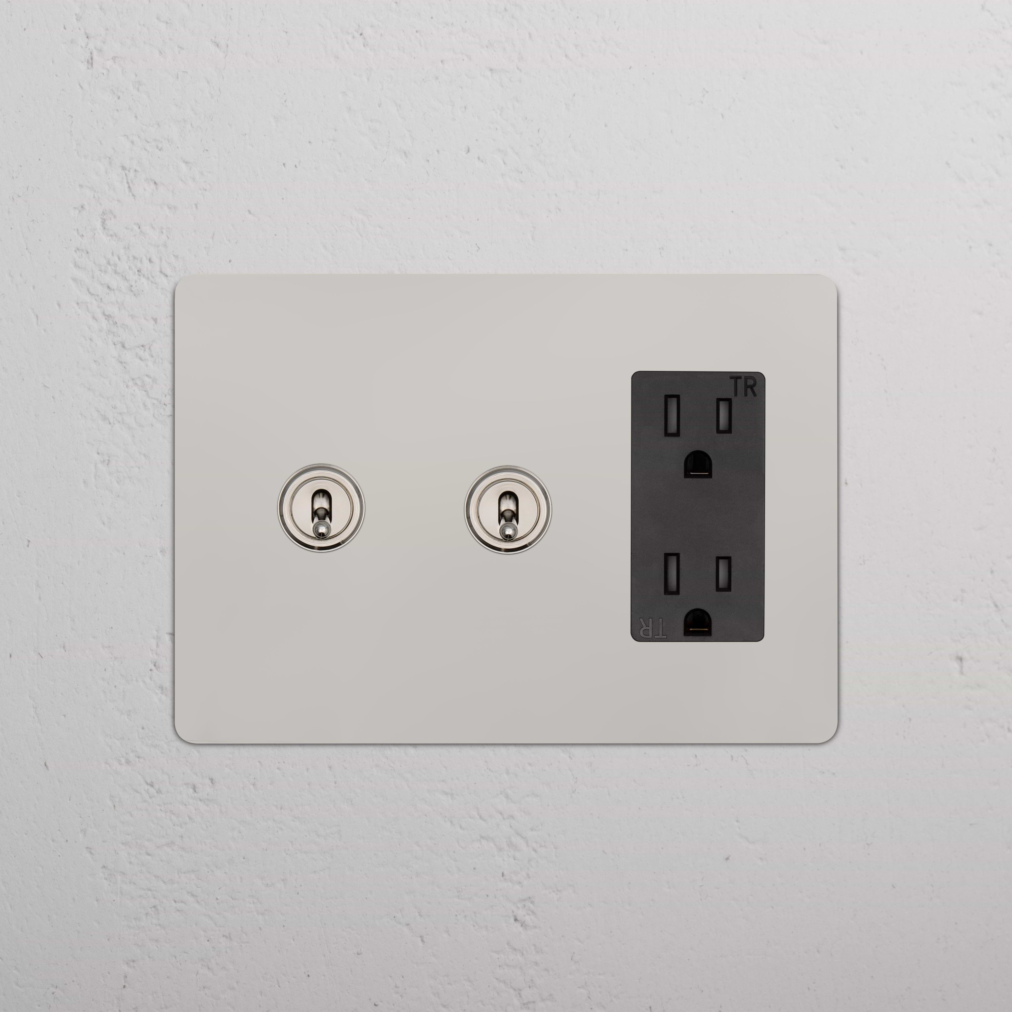 Kew 3G 2x Toggle Switch & Outlet in polished nickel black with two toggles and a three-prong outlet.