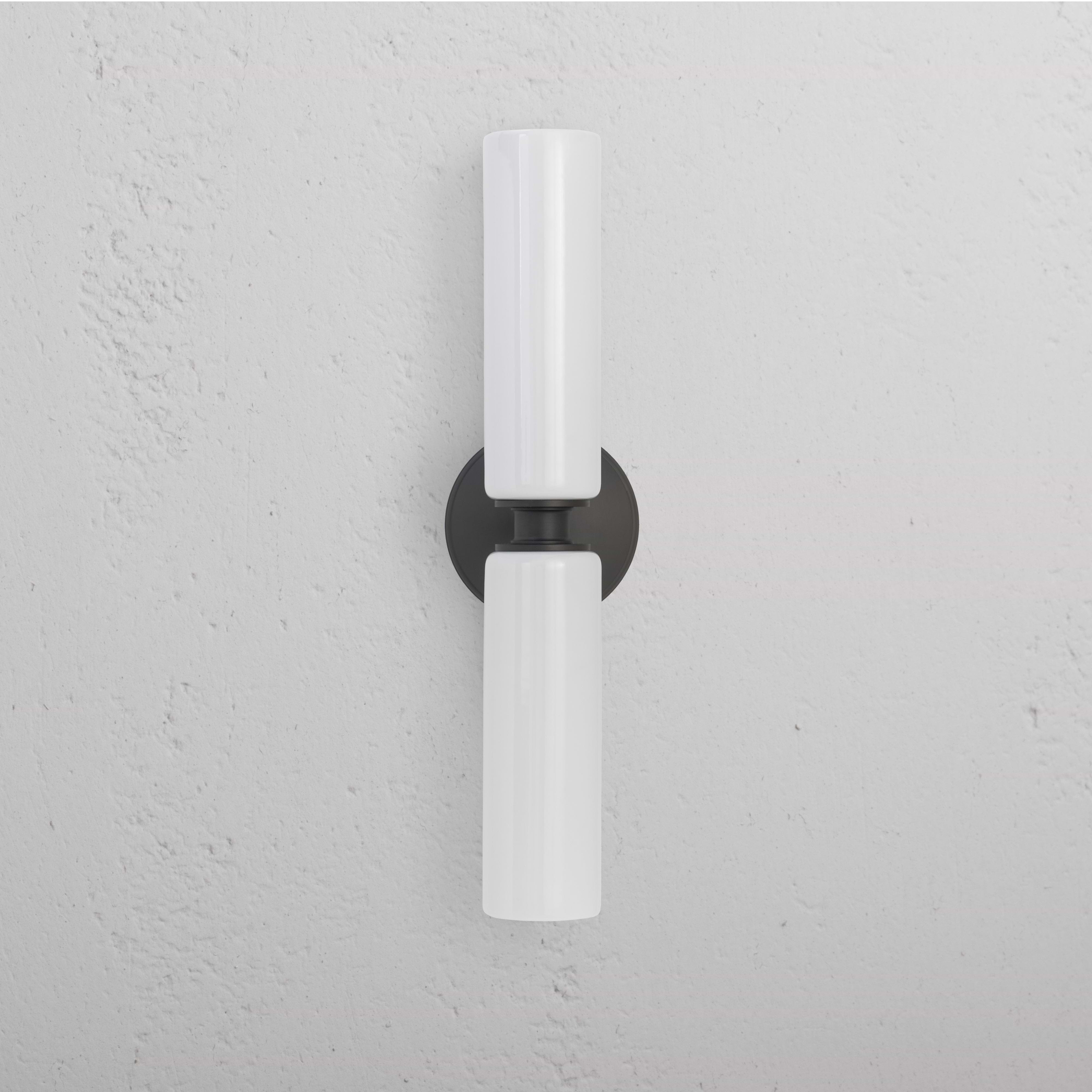 Claremont Medium Wall Light Fine Porcelain in bronze finish, featuring two vertical white porcelain shades.