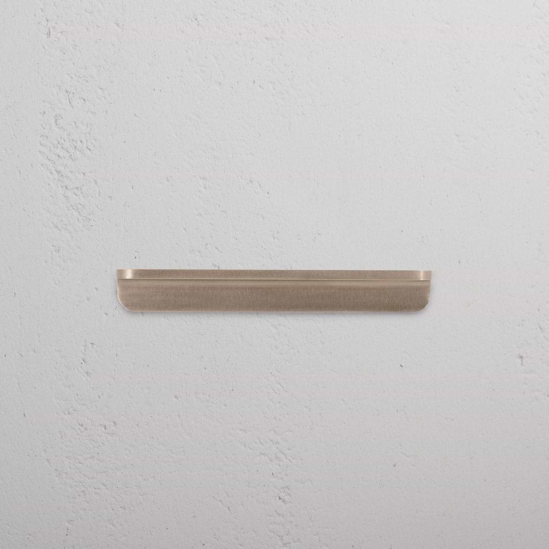 Small antique brass Oxford furniture handle with a classic design, shown against a white background.