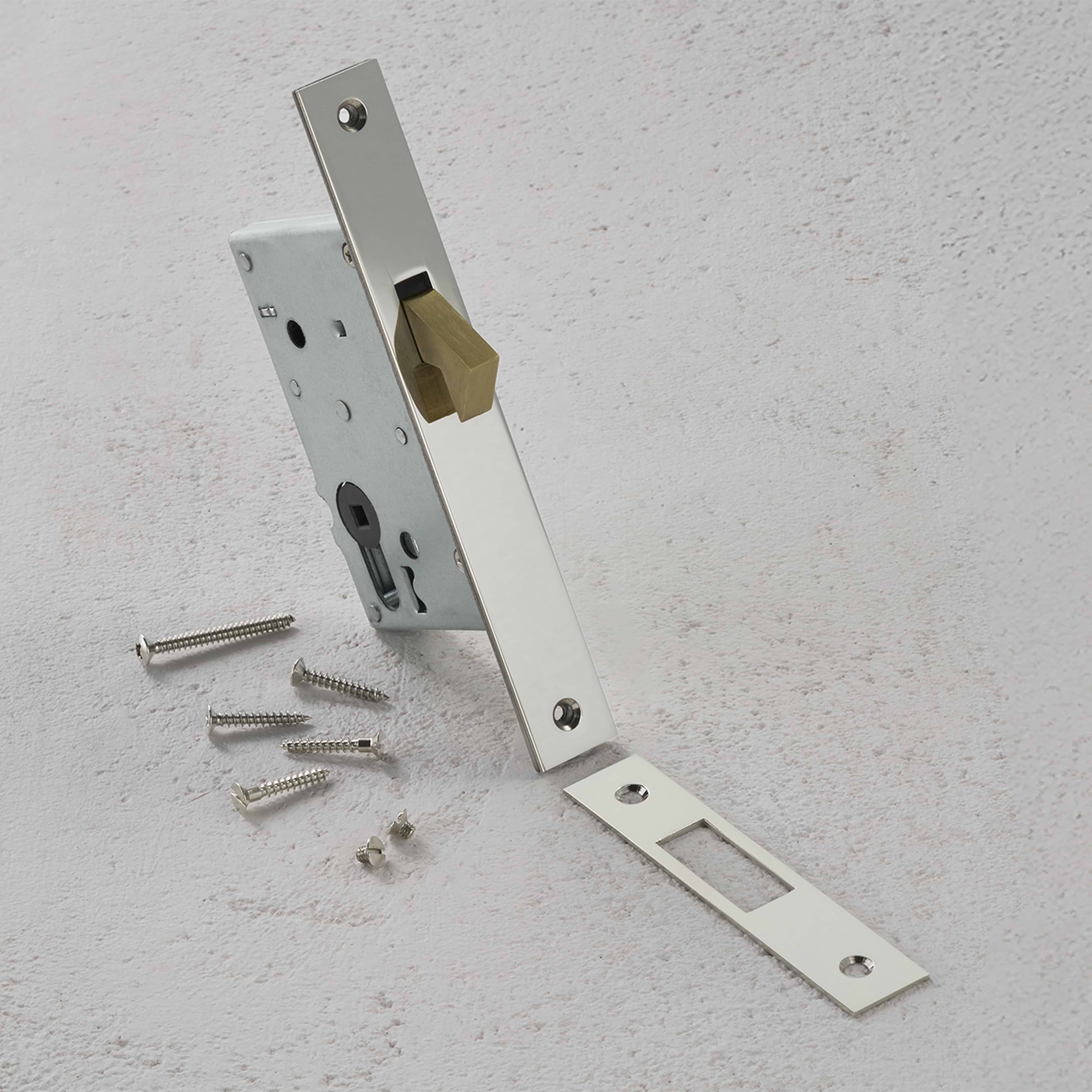 Polished nickel hook lock set with matching strike plate and screws on a light gray surface.