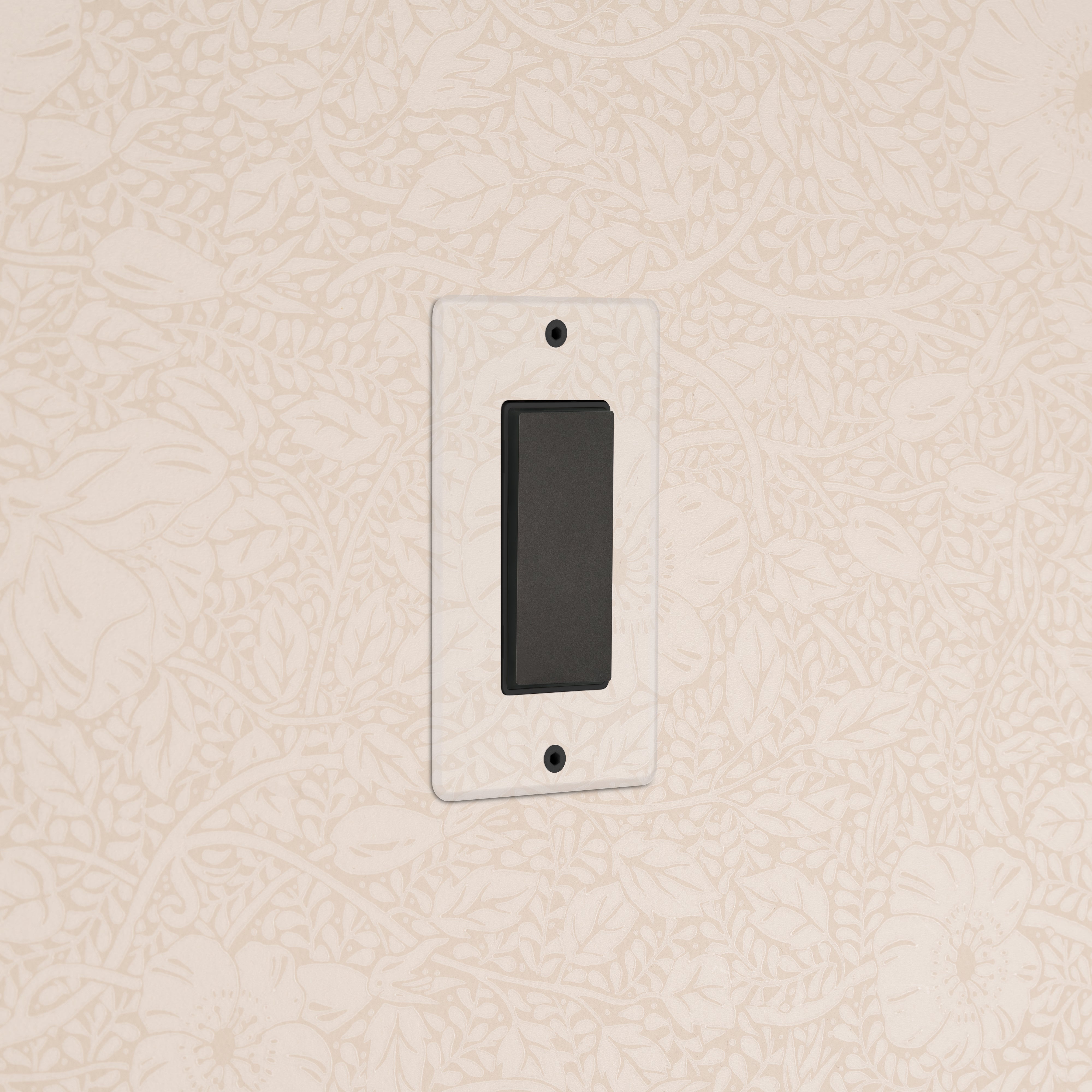 Kew 1G Center Retractive Rocker Switch in Clear Bronze Black, mounted on a floral-patterned beige wall.