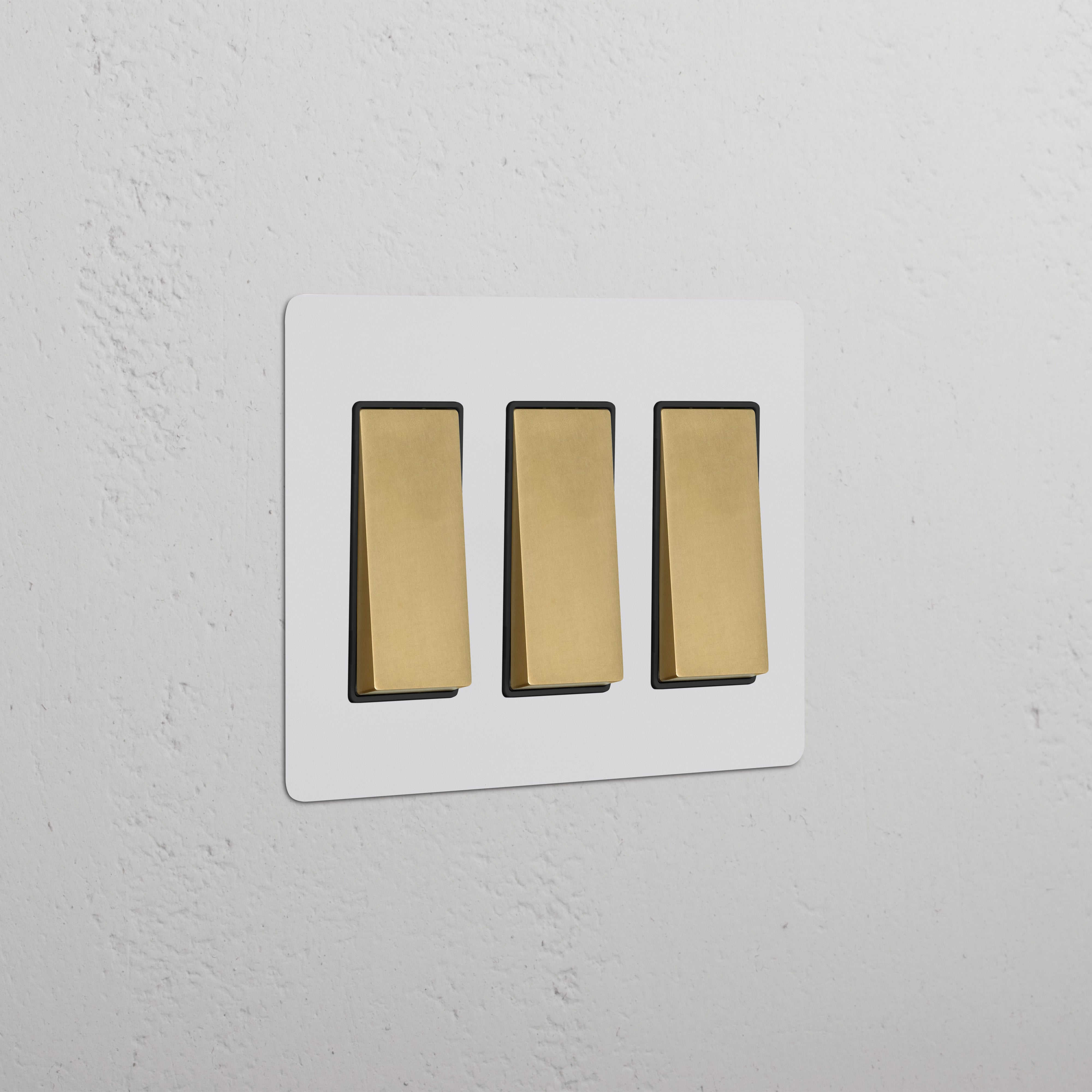Kew 3G Rocker Switch in paintable antique brass black finish, featuring three black rocker switches.