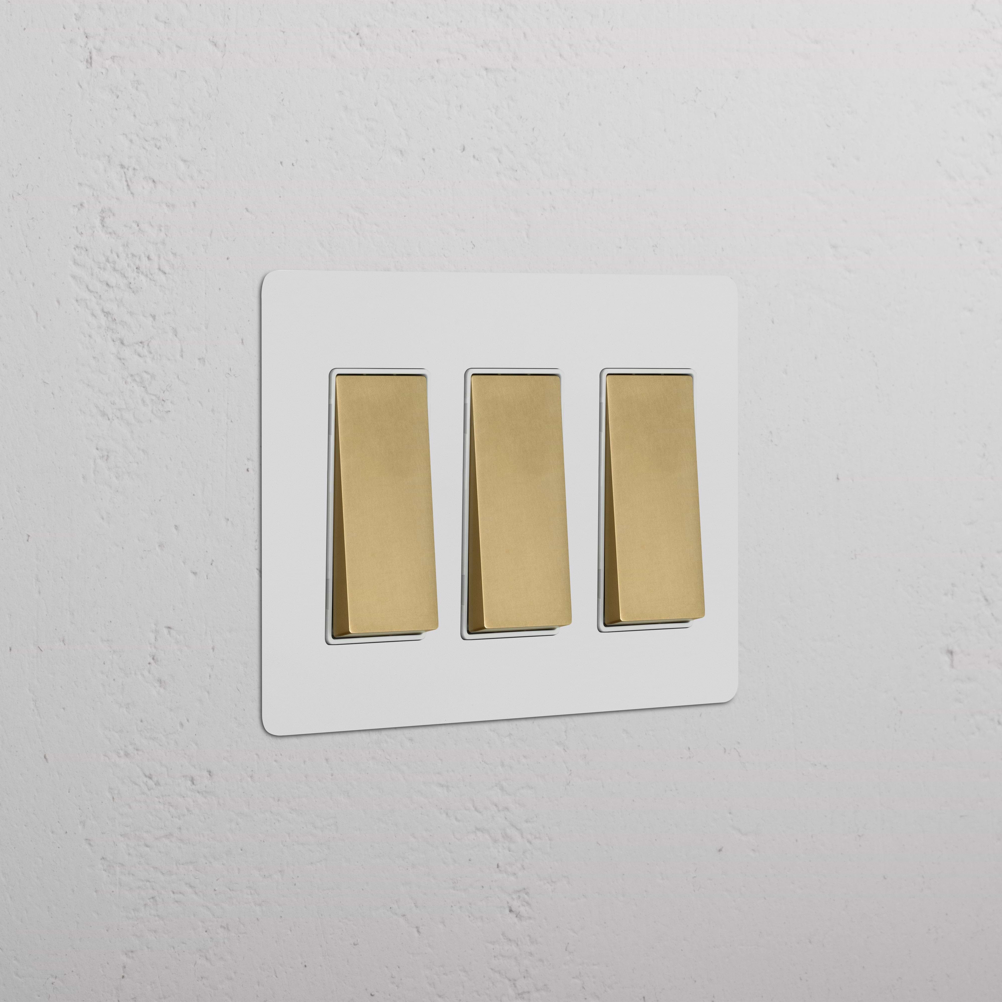 Kew 3G Rocker Switch in paintable antique brass white with three switches on a rectangular plate.