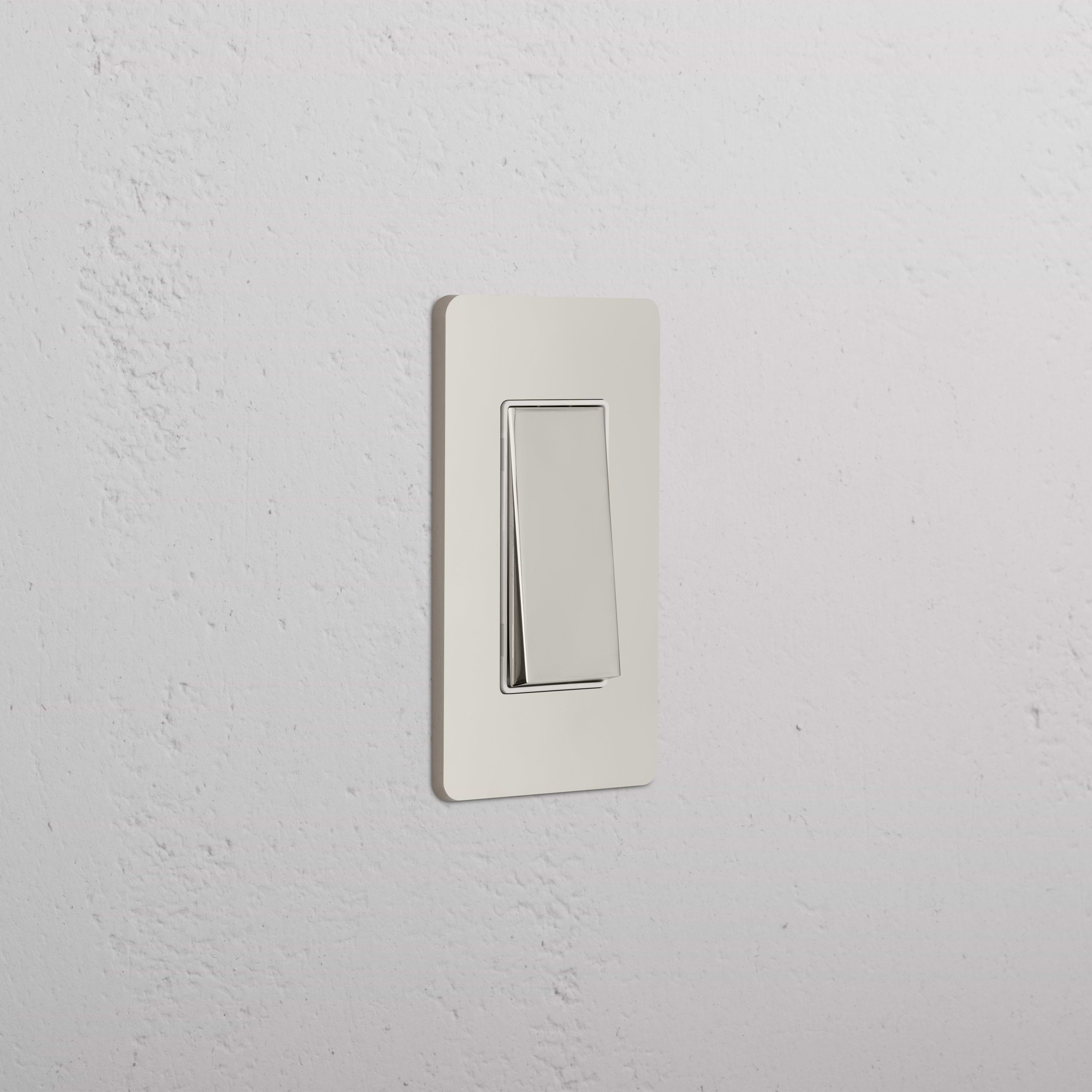 Grove 1G Rocker Switch in Polished Nickel White, rectangular design, mounted on a white wall.