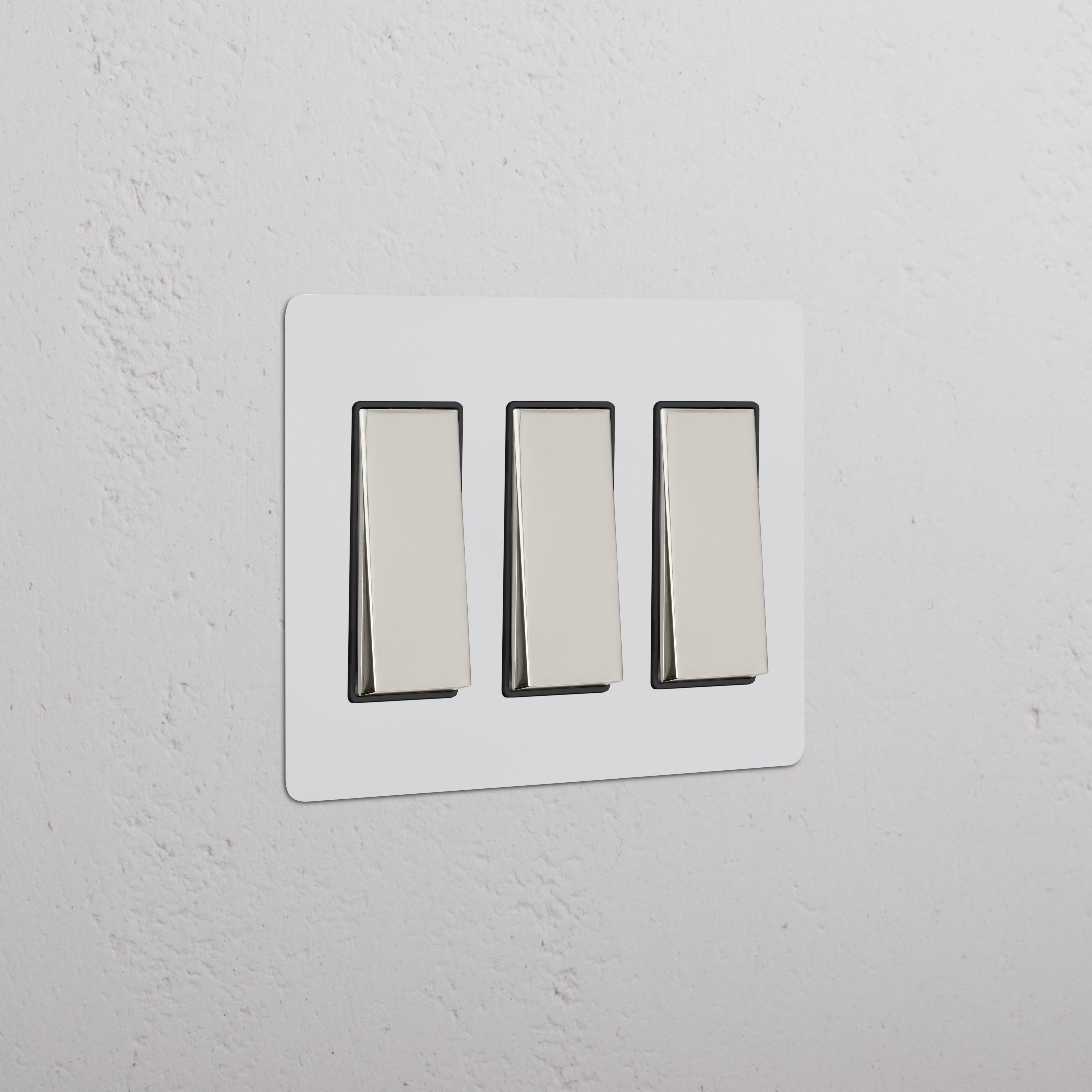 Kew 3G Rocker Switch in Paintable Polished Nickel Black finish, showing three modern rocker switches.