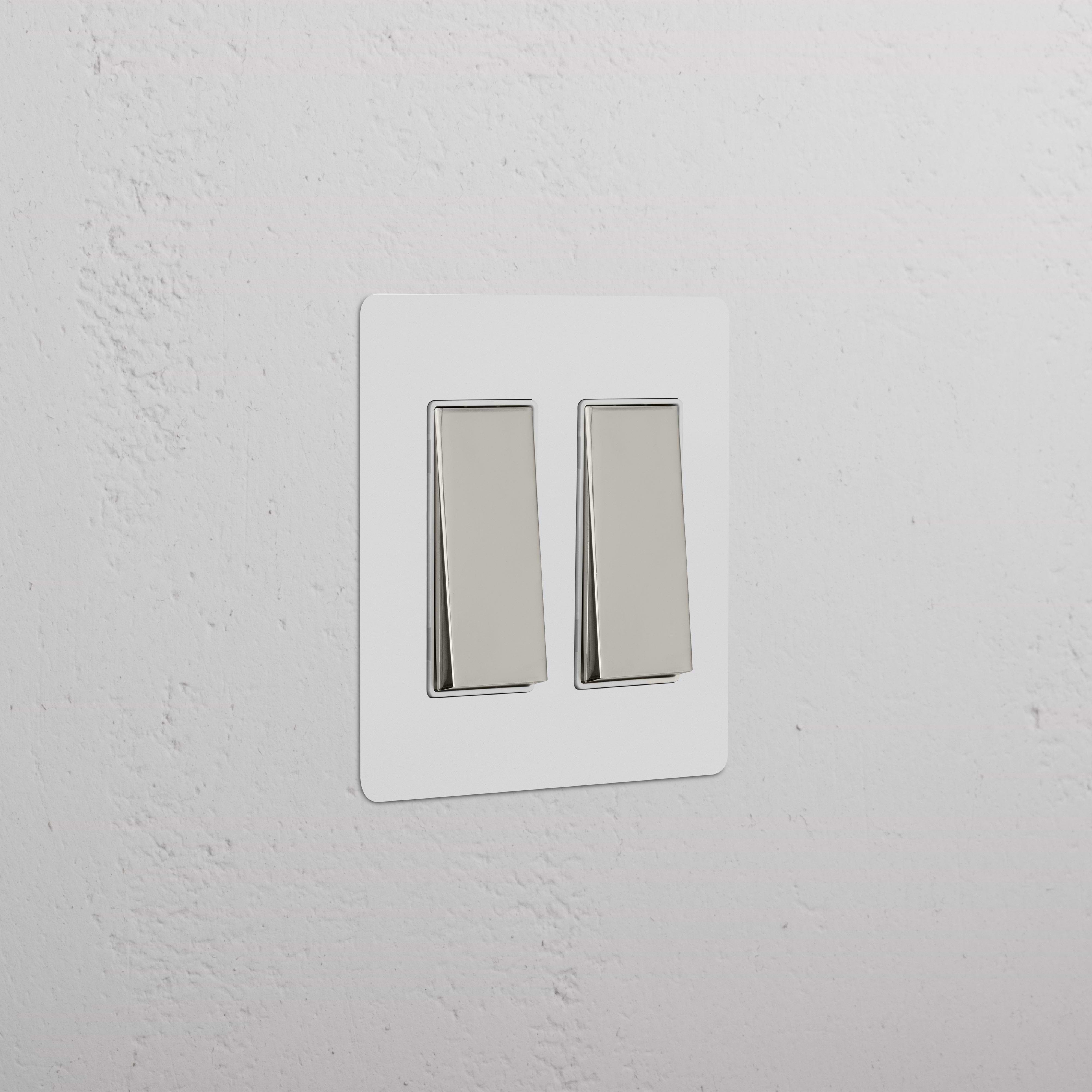 Kew 2G Rocker Switch in paintable polished nickel white finish, featuring two rectangular rocker switches.