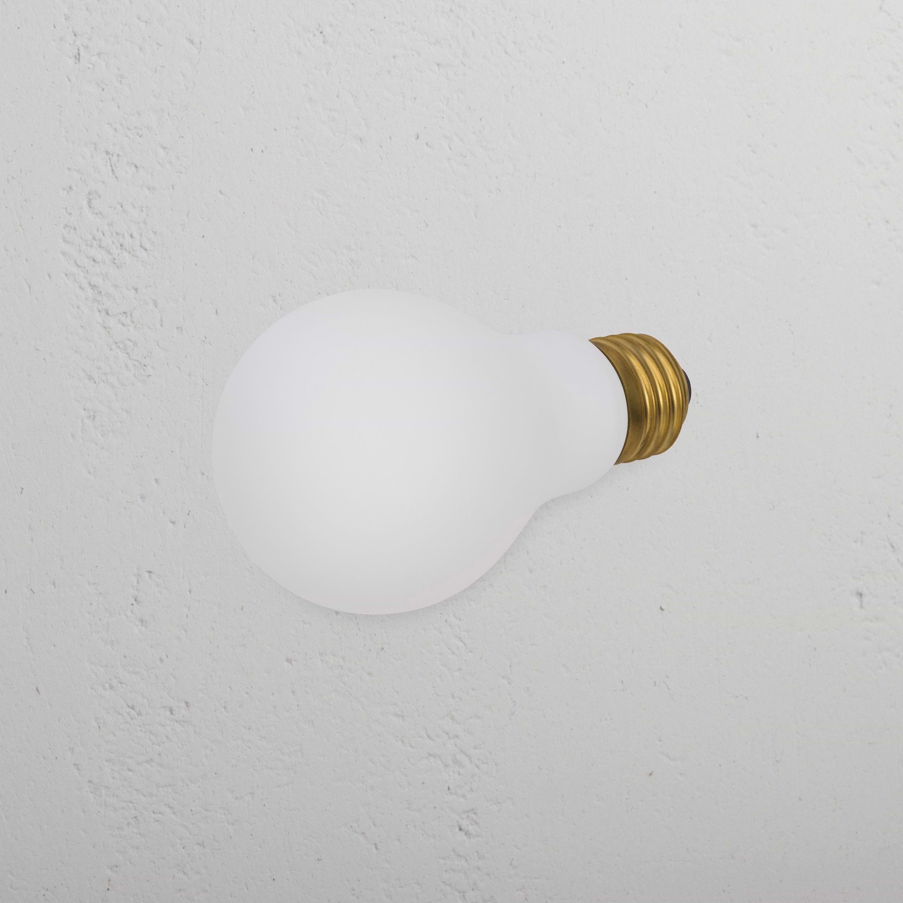 Mulberry 6W LED E26 light bulb with brass screw base resting on a textured white background.