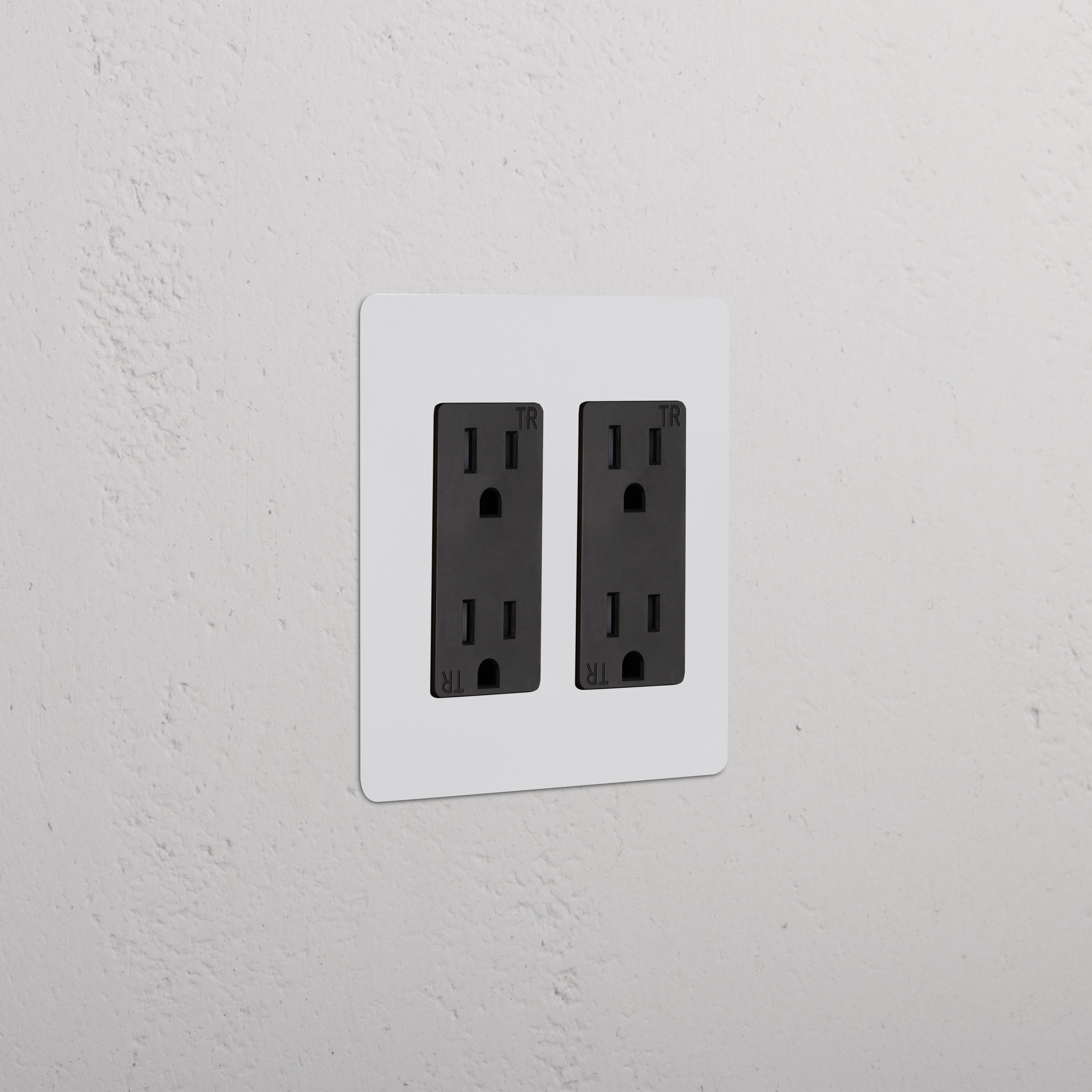 Kew 2G Outlet - Paintable Black double socket with a sleek, paintable black finish on a wall.