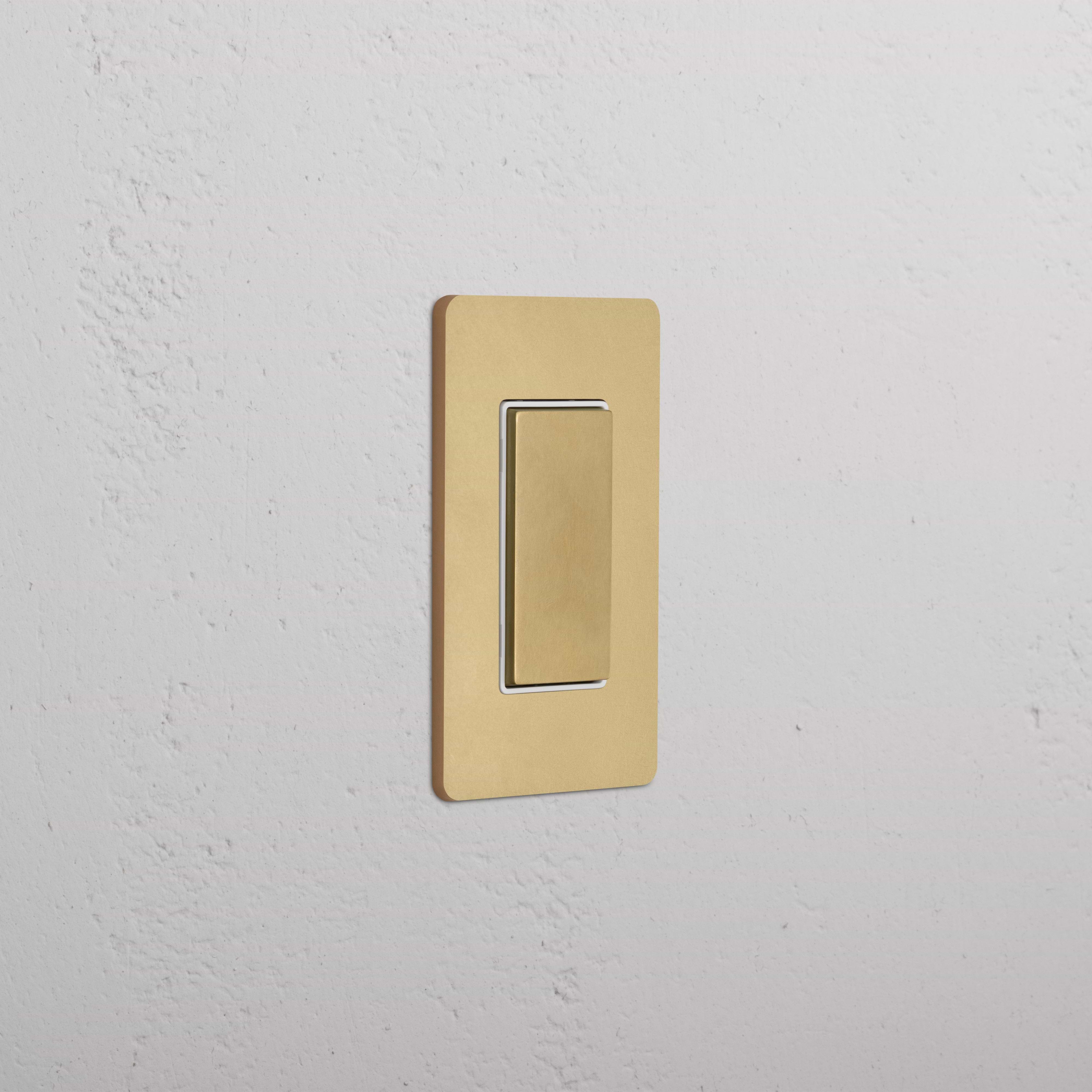 Grove 1G Center Retractive Rocker Switch in Antique Brass White, with gold finish and rectangular plate.