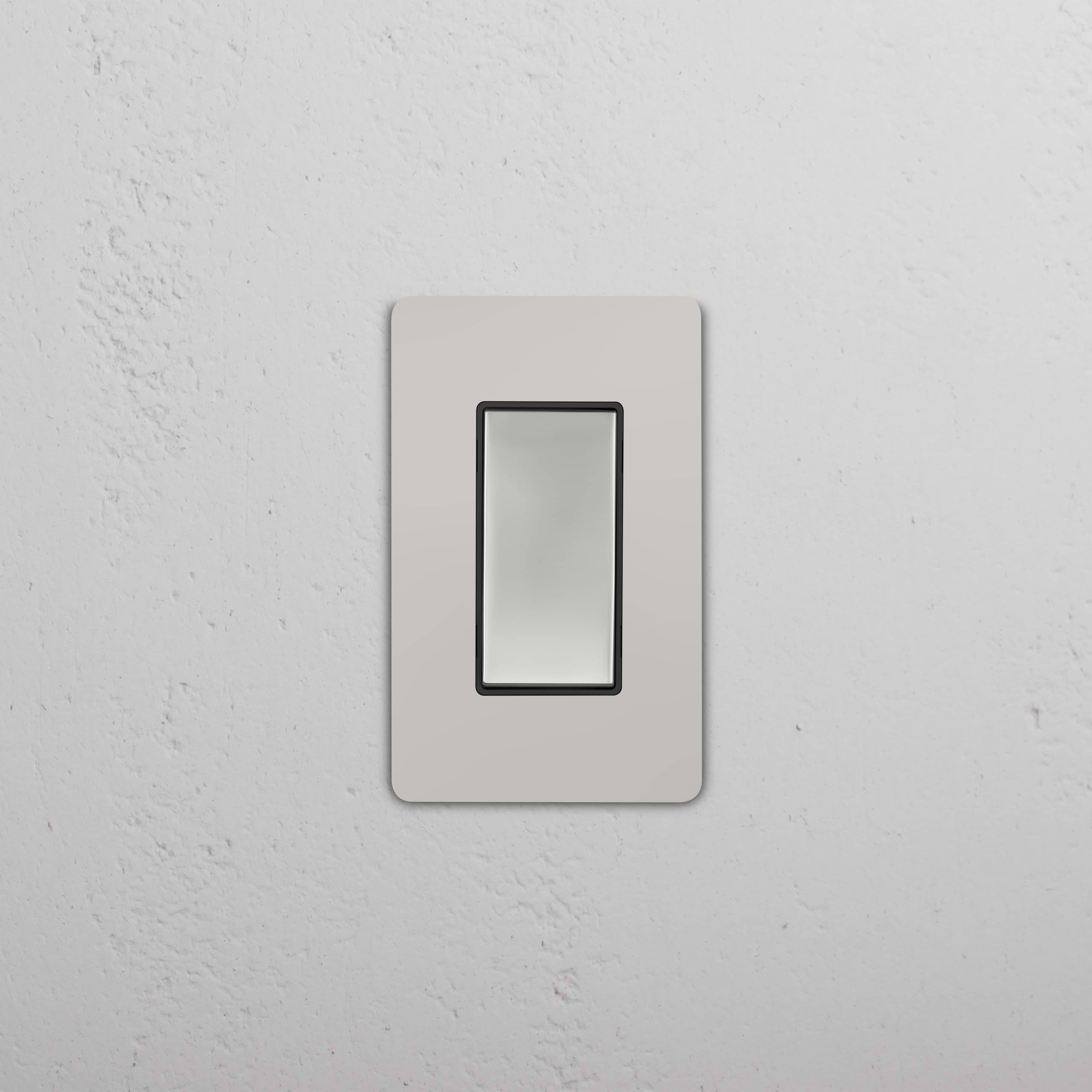Grove 1G Retractive Rocker Switch in polished nickel black finish, shown mounted on a wall.