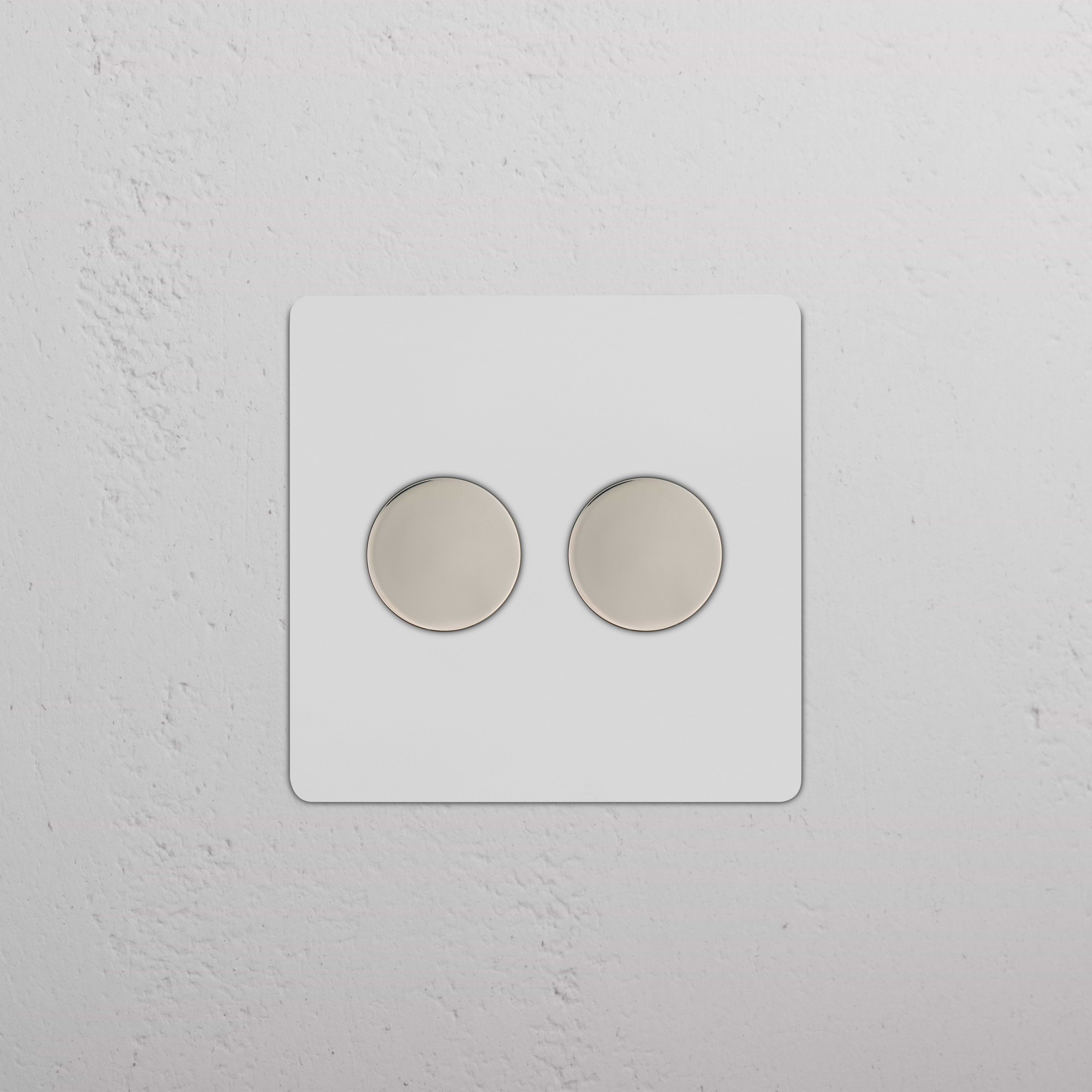 Kew 2G Dimmer Switch - Paintable Polished Nickel with two round dimmer knobs on a wall plate.