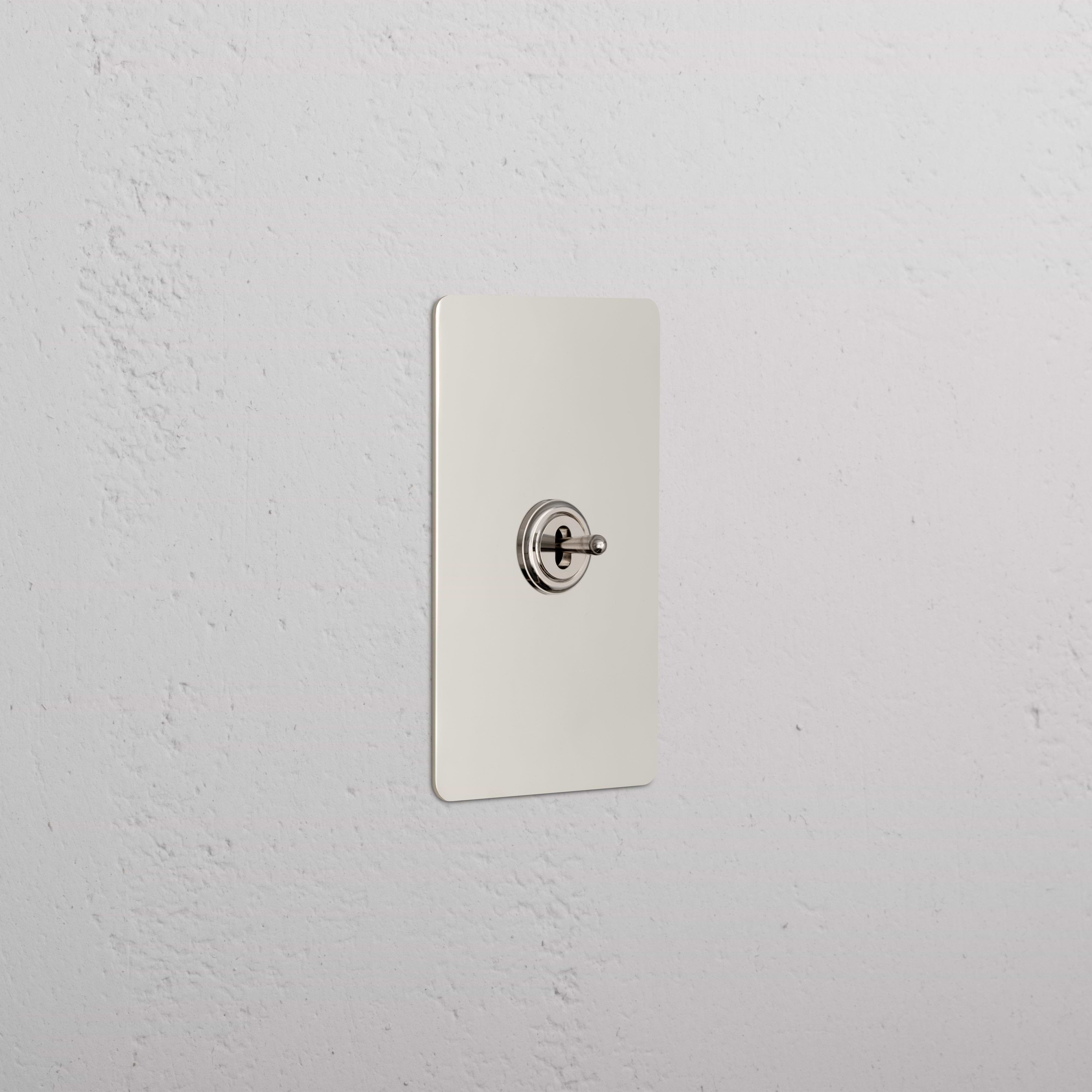 Kew 1G Center Retractive Toggle Switch in polished nickel mounted on a rectangular plate.