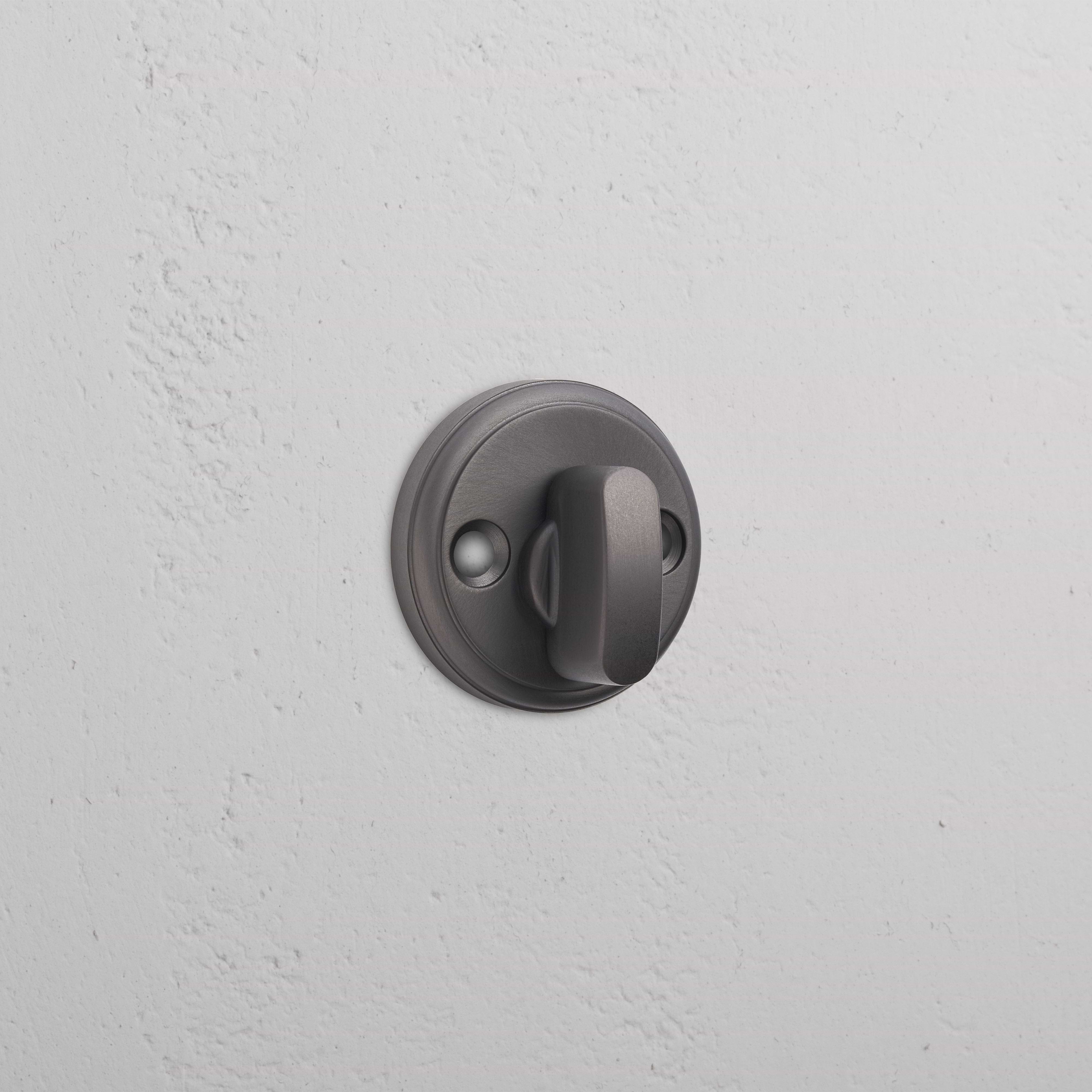 Bronze Canning Privacy Deadbolt with thumbturn installed on a white textured wall.