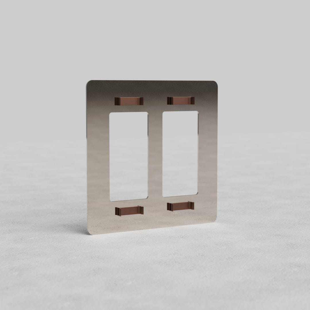 2G Outlet Plate Kew US in polished nickel finish with two rectangular cutouts, shown upright on a gray surface.