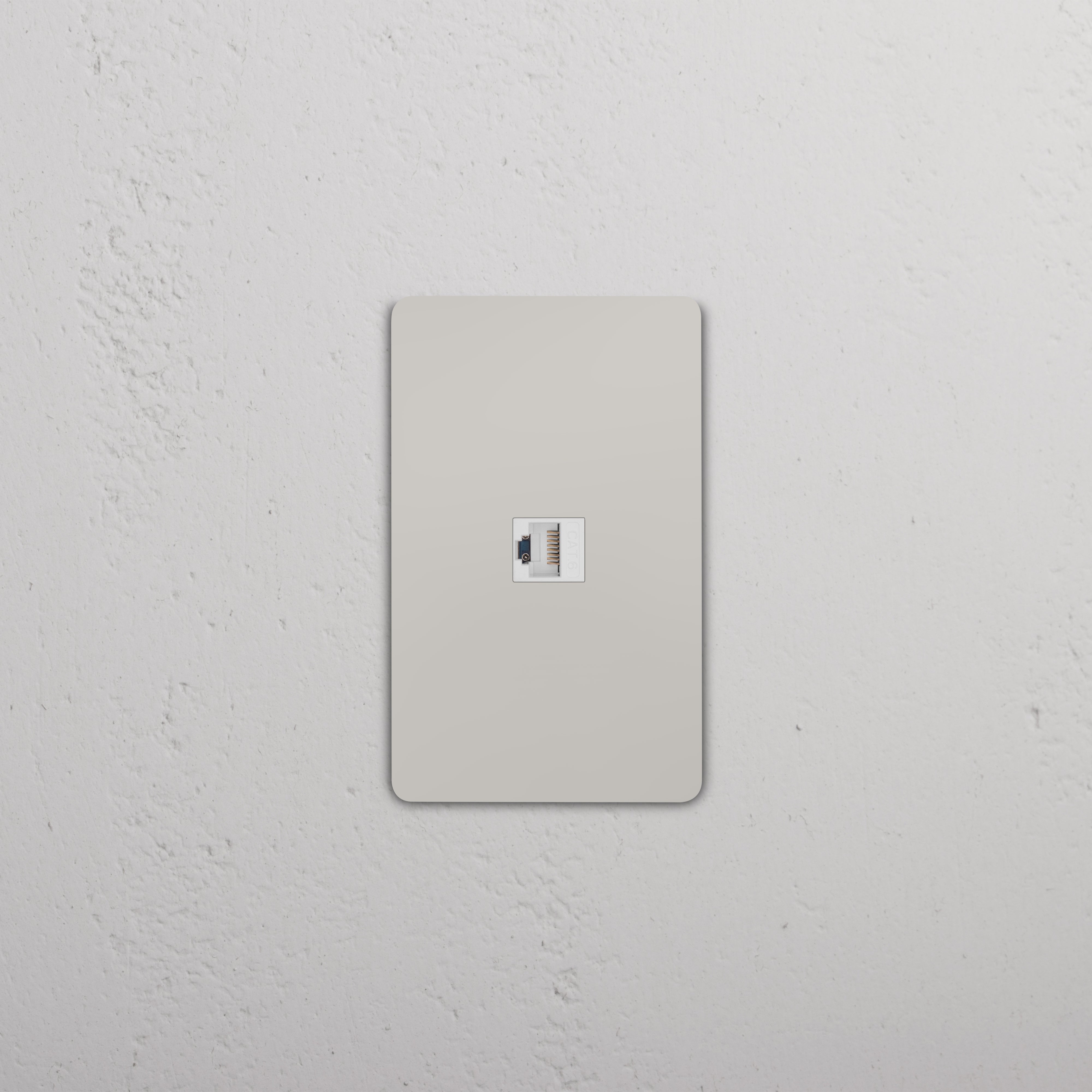 Grove 1G CAT 6 Keystone Ethernet wall plate in polished nickel white finish, shown on a white wall.