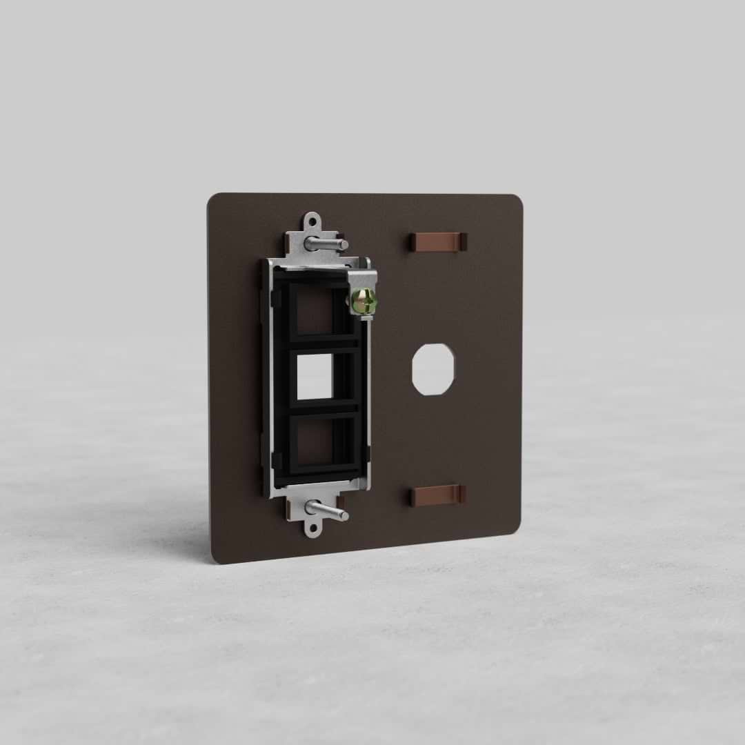 Bronze 2G Switch & Keystone Plate Kew US with three keystone slots, shown upright on a grey background.