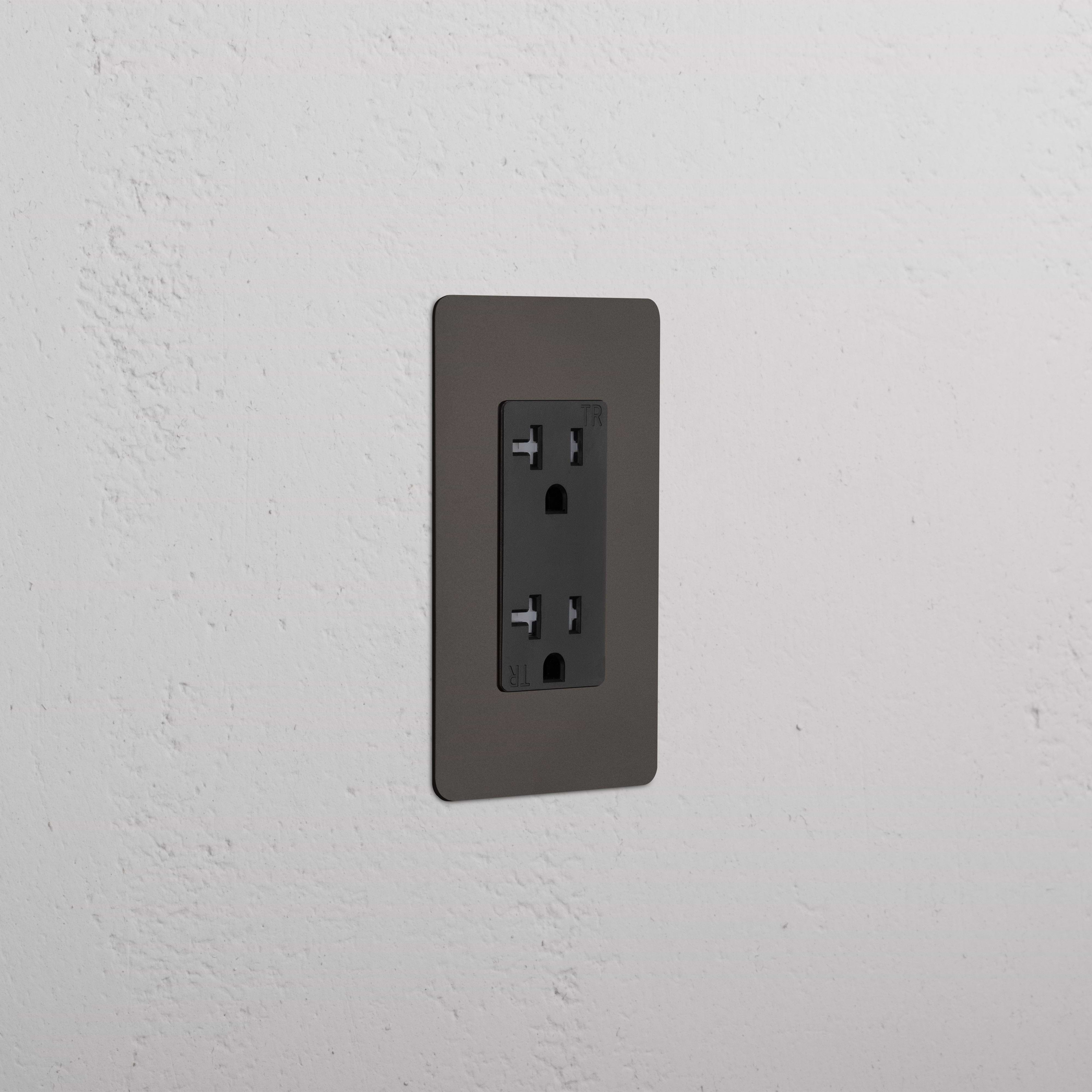 Kew 1G 20A electrical outlet in Bronze Black finish, single socket, shown on a white textured wall.