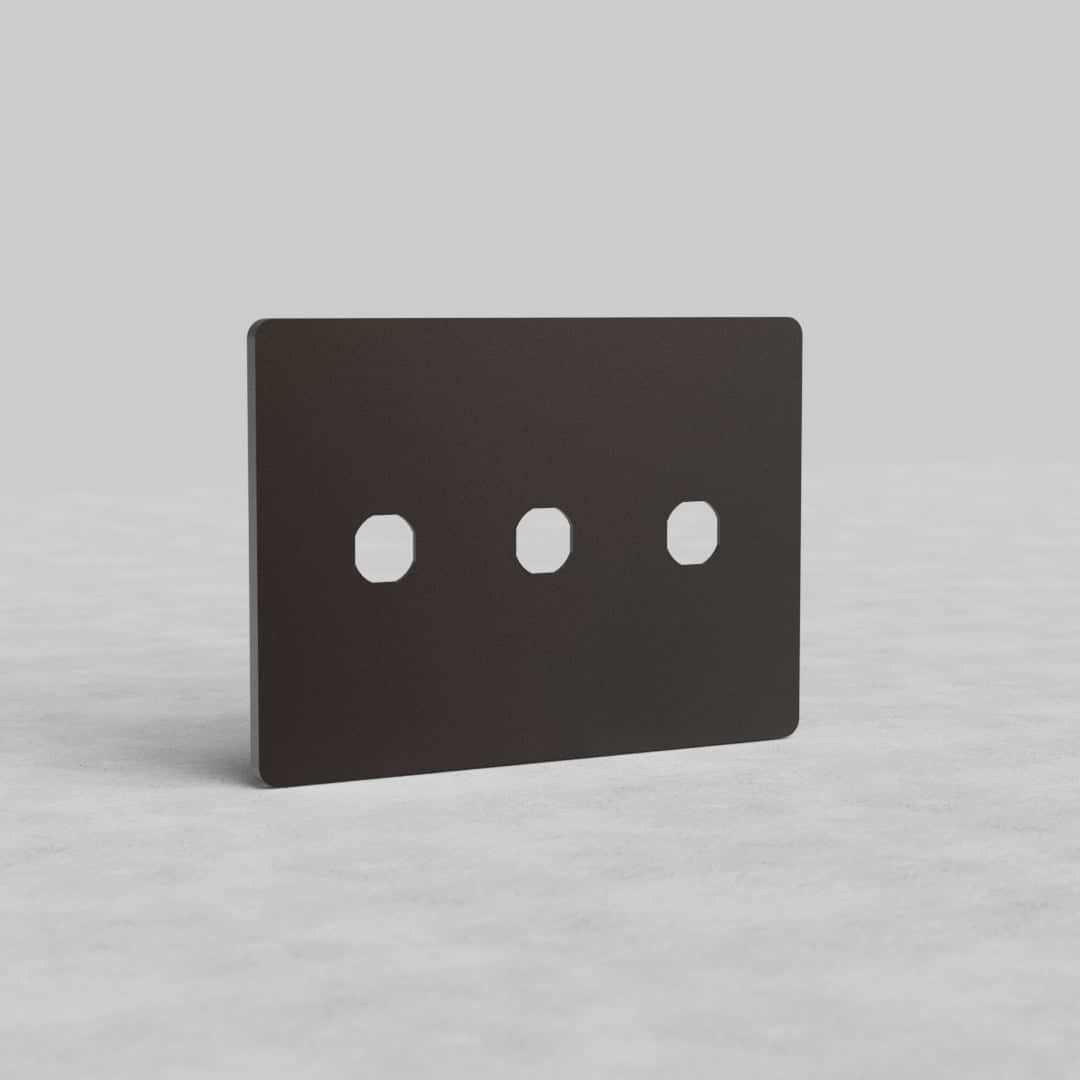 Bronze 3-gang switch plate, Grove US design, with three rectangular switch cutouts on a light surface.