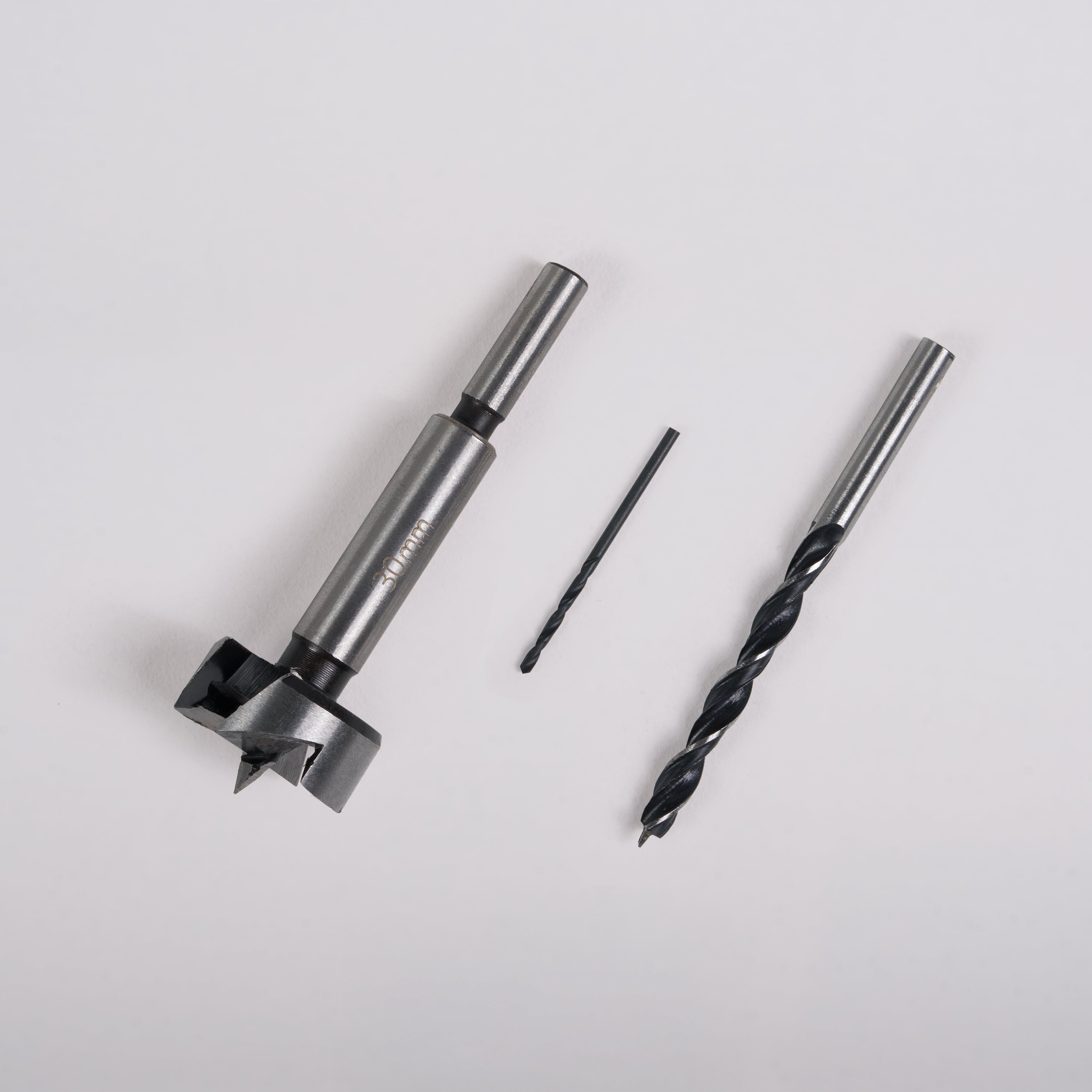 Three Door Handle Installation Drill Bits of different sizes arranged in a row on a light gray background.