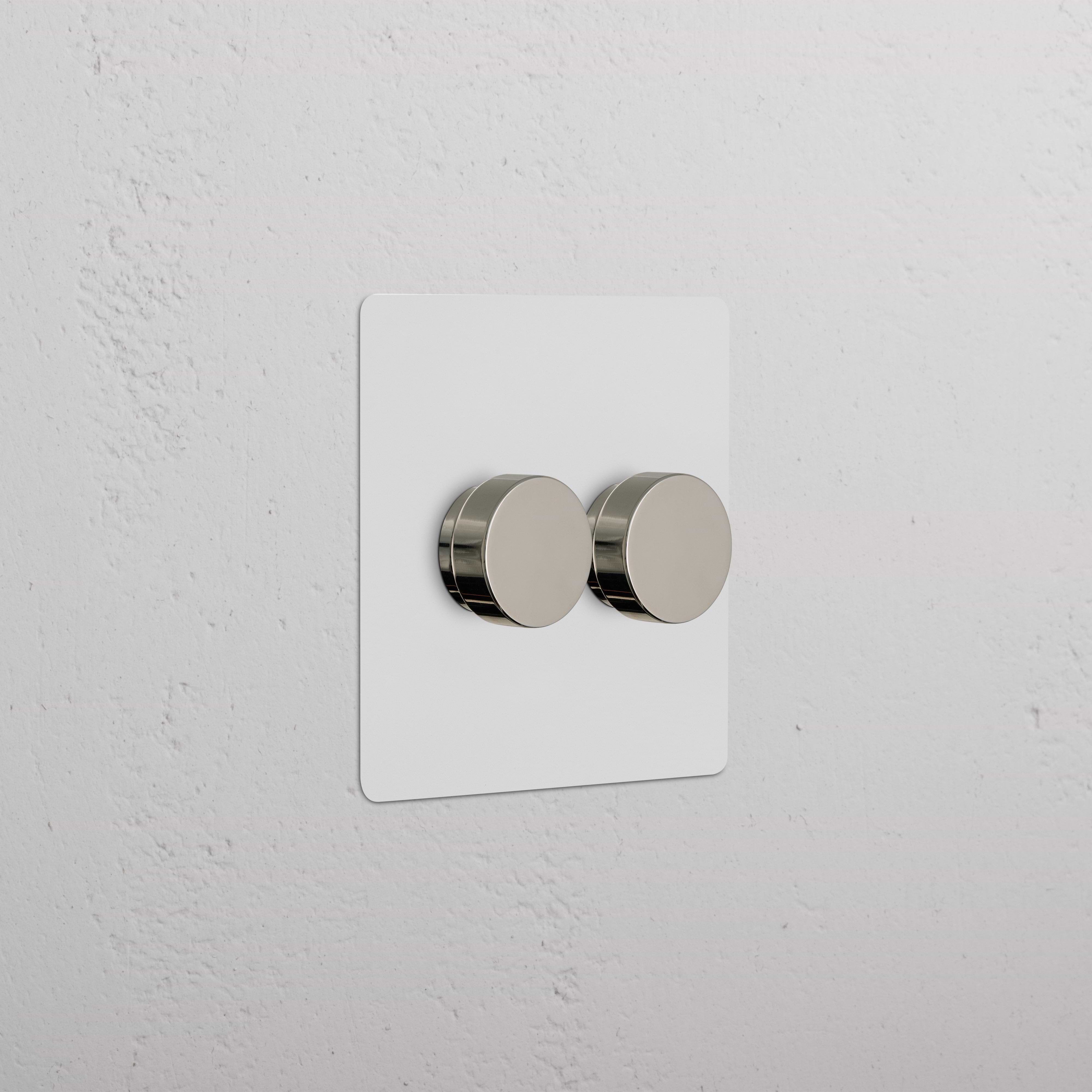Kew 2G Dimmer Switch with two paintable polished nickel knobs on a white rectangular plate.