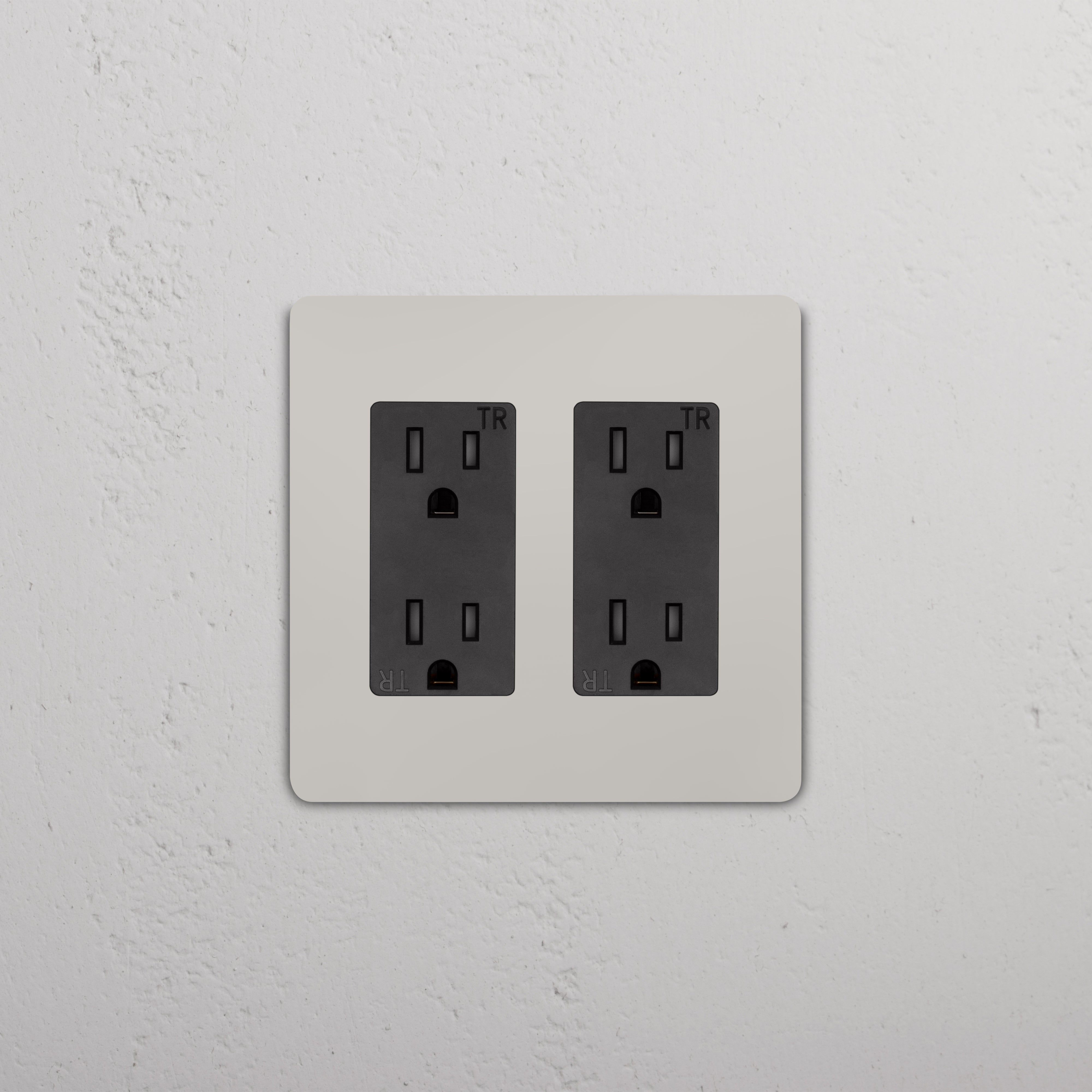 Grove 2G Outlet in Polished Nickel Black with two tamper-resistant three-prong sockets on a textured plate.
