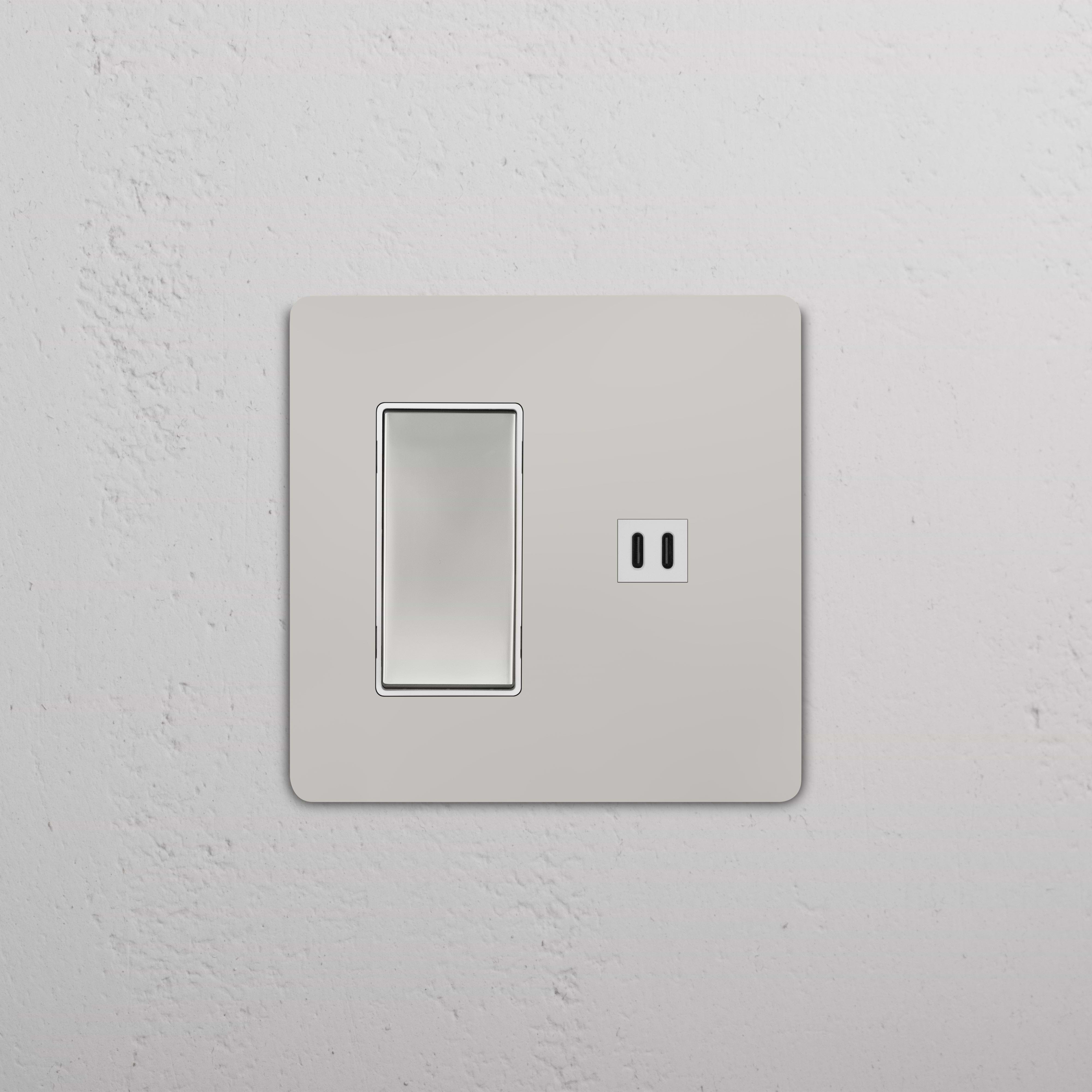 Grove 2G rocker switch with fast charge USB in polished nickel white finish, shown on a white wall.