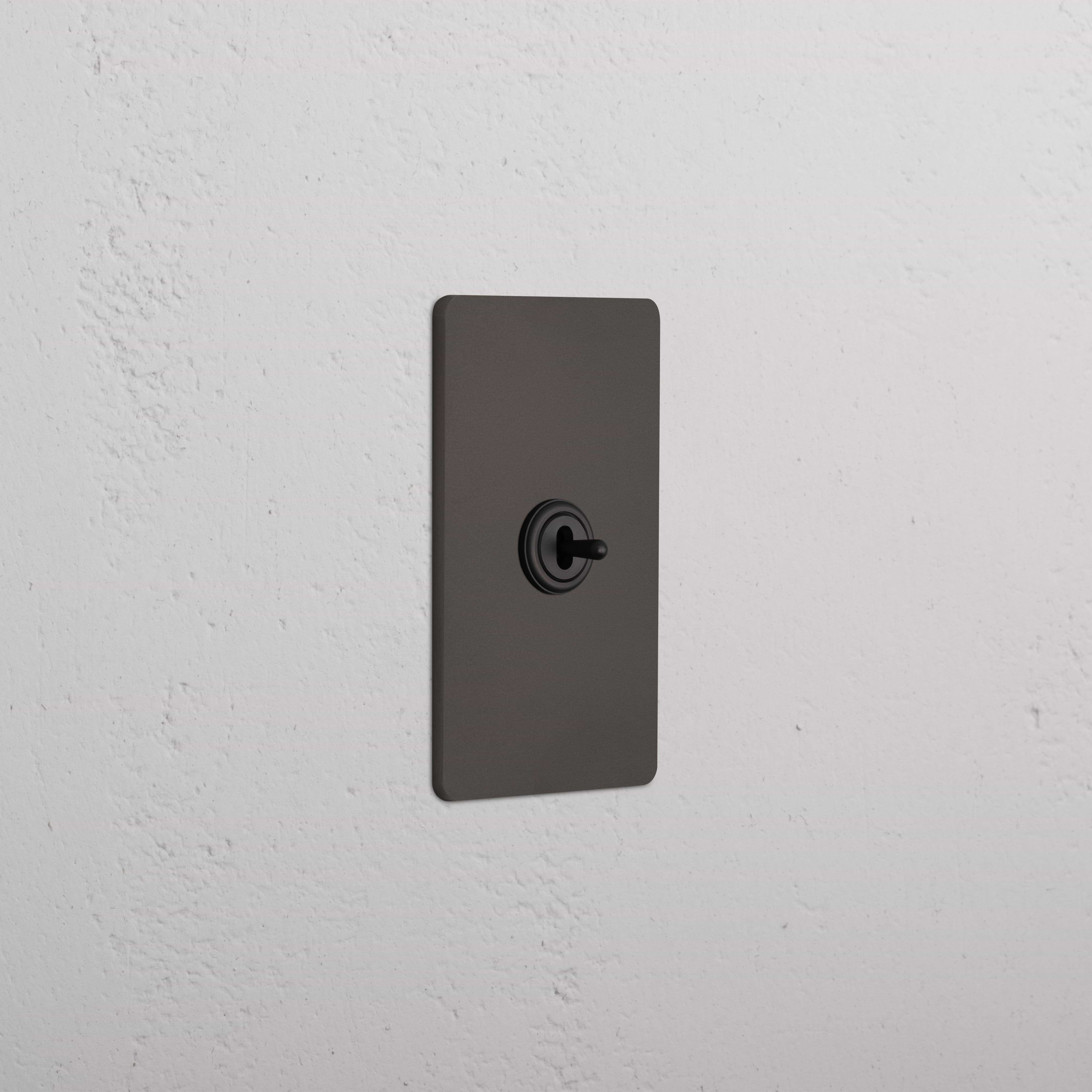 Grove 1G Center Retractive Toggle Switch in bronze with centered toggle and rectangular plate.